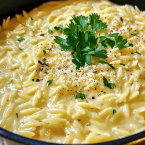 To make this creamy dish, you need just a few key items: - 1 cup orzo pasta - 3 cups vegetable broth - 3 tablespoons butter - 4 garlic cloves, minced - 1 cup heavy cream - 1 cup freshly grated Parmesan cheese - 1 teaspoon dried Italian herbs - Salt and pepper to taste - Fresh parsley, chopped (for garnish) These ingredients work together to create a rich and tasty meal. The orzo acts as the base, soaking up all the flavors. Garlic gives it a nice kick, while butter adds a lovely richness. Heavy cream and Parmesan make it wonderfully creamy. While the core ingredients shine, you can boost the flavor even more with: - A squeeze of lemon juice for brightness - Red pepper flakes for a bit of heat - Cooked vegetables like spinach or peas for added nutrition These extras can really elevate your dish. A touch of lemon can freshen up the creaminess. Red pepper flakes add a fun twist, and veggies make the meal more colorful. If you're out of something or want to switch it up, here are some easy swaps: - Substitute orzo with another small pasta, like ditalini or farro. - Use chicken broth instead of vegetable broth for a meaty flavor. - Swap heavy cream for half-and-half or a non-dairy option like coconut milk. These substitutions help you tailor the dish to your pantry. Don't hesitate to get creative! Each change adds a unique twist to the classic recipe. Start by melting three tablespoons of butter in a large pot. Keep the heat at medium. Once the butter melts, add four minced garlic cloves. Cook the garlic for one to two minutes. Watch it closely to avoid burning. The goal is to get it fragrant. Now, add one cup of orzo pasta. Stir it in and let it toast for one to two minutes. This adds a nice flavor to the orzo. Next, pour in three cups of vegetable broth. Bring this mixture to a boil. After it boils, lower the heat and let it simmer. Cover the pot and let the orzo cook for ten to twelve minutes. Stir it occasionally. The orzo should be al dente and most of the liquid should be absorbed. Once the orzo is cooked, lower the heat again. Add one cup of heavy cream and one cup of freshly grated Parmesan cheese. Stir this mixture well until the cheese melts. It should look creamy and delicious. Sprinkle one teaspoon of dried Italian herbs, along with salt and pepper to taste. Mix everything thoroughly. Remove the pot from heat and let it sit for a couple of minutes. This allows the orzo to thicken up. Finally, serve hot and garnish with freshly chopped parsley. Enjoy your creamy comfort meal! To get that dreamy creamy texture, use heavy cream. It blends well with the Parmesan cheese. Make sure to stir the mixture well after adding the cream and cheese. This helps mix everything evenly. Let it sit for a few minutes after cooking. This resting time helps it thicken just right. If the orzo seems too thick, add a splash more vegetable broth or cream. Adding a splash of lemon juice lifts the flavors. It gives a nice bright taste. Fresh herbs like basil or thyme can also add depth. You might try red pepper flakes for a kick. Don't forget to taste as you go. Adjust salt and pepper to your liking. This way, you make the dish truly yours. One common mistake is not stirring enough. Stirring helps the orzo cook evenly and prevents sticking. Avoid cooking the garlic too long. Burnt garlic can ruin the dish. Lastly, don’t skip letting it rest before serving. This step helps the orzo absorb the sauce. Remember, patience pays off in creamy comfort meals! {{image_2}} You can boost the nutrition of your orzo dish easily. Try adding vegetables like spinach, peas, or cherry tomatoes. Just stir them in when the orzo is almost done cooking. This adds color and taste. You can also use bell peppers or zucchini for more crunch. These veggies will cook quickly and blend well with the creamy sauce. Adding protein makes this meal even heartier. You can mix in cooked chicken, shrimp, or sausage. For a quick option, use rotisserie chicken. If you want to keep it light, try adding canned chickpeas or white beans. Mix in the protein just before serving to heat it through. This makes your dish filling and satisfying. To make a vegan version, swap out the butter and cream. Use olive oil instead of butter and coconut cream or a cashew cream for richness. Replace Parmesan cheese with a vegan cheese alternative or nutritional yeast. This will give you that cheesy flavor without dairy. Follow the same steps, and you’ll have a creamy, plant-based meal that everyone will enjoy. You can store your One-Pot Garlic Parmesan Orzo in the fridge for up to five days. Place the orzo in an airtight container. Make sure it cools down before sealing the lid. This keeps it fresh and tasty for your next meal. If you want to keep it longer, freeze the orzo. Use a freezer-safe container and fill it, leaving space for expansion. It’s best to freeze it within two days of cooking. To thaw, move it to the fridge overnight before reheating. When you’re ready to enjoy your orzo again, reheat it on the stove. Add a splash of vegetable broth or cream to help it regain its creamy texture. Heat over medium-low heat, stirring often. You can also use the microwave; just cover it and heat in short bursts, stirring in between. Yes, you can use other small pasta shapes like ditalini or small shells. The cooking time may change, so check the package for specifics. Make sure to adjust the liquid as needed. For best results, stick to pasta that cooks in about 10-12 minutes. To make this dish gluten-free, simply swap the orzo with a gluten-free pasta. Many brands offer gluten-free orzo or similar shapes. Always check the labels to ensure they meet your dietary needs. The cooking time might vary, so keep an eye on it. This orzo pairs well with grilled chicken or roasted vegetables. A fresh salad with a light vinaigrette also complements the dish nicely. You might enjoy it with crusty bread for a comforting meal. For a fun twist, try serving it with shrimp or scallops. This blog post explored how to make One-Pot Garlic Parmesan Orzo. We discussed essential and optional ingredients, including substitutions. I provided step-by-step instructions to cook orzo with garlic and broth, ensuring creamy results. Helpful tips showed how to enhance flavors and avoid mistakes. We also covered variations with veggies, proteins, and a vegan option. Lastly, we shared best storage practices for leftovers. Enjoy this dish's simplicity and taste, and feel free to experiment with your favorite flavors. You’ll love how easy and satisfying it is!