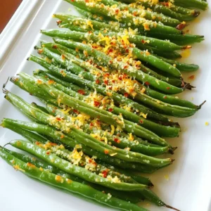 To make crispy roasted Parmesan green beans, you need: - 1 pound fresh green beans, trimmed - 2 tablespoons olive oil These seasonings bring out the flavor: - ½ cup grated Parmesan cheese - 1 teaspoon garlic powder - ½ teaspoon onion powder - Salt and pepper to taste Want to spice things up? Try these: - ½ teaspoon crushed red pepper flakes - 1 tablespoon lemon zest for a fresh twist Start by preheating your oven to 425°F (220°C). This hot temperature helps the green beans get crispy. Line a baking sheet with parchment paper. This step makes cleanup much easier. A clean sheet allows the beans to roast well. In a large bowl, add 1 pound of trimmed green beans. Pour in 2 tablespoons of olive oil. Then, add ½ cup of grated Parmesan cheese. This cheese gives a rich, savory flavor. Next, sprinkle in 1 teaspoon of garlic powder and ½ teaspoon of onion powder. These spices add depth to the dish. If you like heat, include ½ teaspoon of crushed red pepper flakes. Finally, season with salt and pepper to taste. Toss everything together until the green beans are well-coated. Spread the green beans in a single layer on your baking sheet. Make sure they are not crowded. This helps them roast evenly. Place the sheet in the oven and roast for 15-20 minutes. Halfway through, stir the green beans for even cooking. Look for a crispy, golden-brown color. Once they are done, take them out and sprinkle with lemon zest for a fresh twist. Let them cool for a few minutes before serving. This cooling time helps them crisp up even more. To get your green beans super crispy, start with fresh beans. Trim them well, so they roast evenly. Use a large bowl to toss them with olive oil and seasonings. The oil helps the beans crisp up. Spread them out on the baking sheet in a single layer. This step is key! If they are crowded, they will steam instead of crisp. Stir them halfway through roasting to ensure all sides get that golden brown color. To add extra flavor, sprinkle in garlic powder and onion powder. These spices boost the taste without being overpowering. For a kick, use crushed red pepper flakes. They add a nice heat that pairs well with the cheese. Don’t forget the lemon zest! It brightens the dish and adds freshness. Mix in extra Parmesan cheese before serving for a cheesy explosion. These crispy green beans shine on their own but can also pair well with other dishes. Serve them alongside grilled chicken or fish for a full meal. You can also add them to salads for crunch. For a fun twist, offer a dip like ranch or hummus. Place the green beans on a platter, and garnish with more lemon zest and cheese. This makes for a beautiful presentation. {{image_2}} To make spicy Parmesan green beans, add crushed red pepper flakes. I love the heat! You can start with ½ teaspoon for a mild kick. If you want more spice, add more flakes. Toss them in with the green beans before roasting. This adds a fun twist to the flavor. Try balsamic glazed green beans for a sweet and tangy taste. Drizzle 2 tablespoons of balsamic vinegar over the green beans before roasting. This adds a rich flavor that pairs well with the Parmesan. The glaze caramelizes a bit in the oven, giving them a shiny look too. For cheesy herb green beans, mix in fresh herbs like thyme or rosemary. I recommend using 1 tablespoon of finely chopped herbs. You can also add an extra ¼ cup of Parmesan cheese for more flavor. The herbs bring freshness while the cheese adds richness. This makes the dish even more delicious. Each of these variations gives a new twist to crispy roasted Parmesan green beans. Feel free to mix and match flavors to find your favorite! Store leftover crispy roasted Parmesan green beans in an airtight container. They stay fresh for up to three days in the fridge. Make sure to cool them down before sealing. This keeps them crispy and tasty. If you have many leftovers, divide them into smaller containers. To reheat, use the oven for best results. Preheat the oven to 350°F (175°C). Spread the green beans on a baking sheet. Heat for about 10 minutes, or until hot and crisp again. You can also use an air fryer. Set it to 350°F (175°C) and heat for 5-7 minutes. This method keeps them crunchy. Freezing is not the best option for crispy green beans. They lose their crunch when thawed. If you must freeze them, do so before roasting. Blanch the fresh green beans in boiling water for two minutes. After cooling them quickly in ice water, dry them off well. Place in freezer bags and freeze for up to three months. When ready to cook, roast them straight from the freezer. Adjust cooking time as needed. Yes, you can use frozen green beans. They work well in this recipe. Just remember to thaw them first. Pat them dry with a towel to remove excess moisture. This step helps them get crispy in the oven. Frozen beans may take a few extra minutes to cook. Check for crispiness before removing them from the oven. To make green beans crispy, follow these steps: - Use fresh green beans for the best texture. - Coat them evenly with olive oil and spices. - Spread them in a single layer on the baking sheet. - Roast at a high temperature, around 425°F (220°C). - Stir halfway through cooking to ensure even crispness. These tips help create that crunchy texture you want. The key is to avoid crowding the pan. This allows hot air to circulate around the beans. Several dips pair well with crispy green beans. Here are a few tasty options: - Ranch dressing offers a cool, creamy contrast. - Garlic aioli adds a rich, bold flavor. - Spicy sriracha mayo gives a kick to your green beans. - Honey mustard provides a sweet and tangy option. Try these dips to enhance your snacking experience. You can even mix and match to find your favorite combination! This blog post covered fresh ingredients, essential seasonings, and optional add-ins for green beans. We walked through how to prep, mix, and roast them for that perfect crispiness. I shared tips for enhancing flavor and serving ideas. You learned about delicious variations like spicy Parmesan and cheesy herb options. Remember how to store leftovers and reheat them to keep their taste. By following these steps and tips, you’ll whip up tasty green beans every time. Enjoy your cooking adventure!