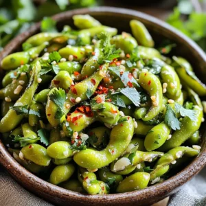 - 2 cups frozen edamame in pods - 2 tablespoons olive oil - 4 cloves garlic, minced - 1 teaspoon red pepper flakes (adjust to taste) - 1 tablespoon soy sauce - 1 teaspoon sesame oil - Salt to taste - Fresh cilantro for garnish To make Air Fryer Spicy Garlic Edamame, I start with frozen edamame in pods. You can find these at most stores in the frozen section. They provide a great texture and flavor. Next, I use olive oil to help the seasoning stick. It gives a rich taste. Garlic adds a strong and savory flavor. I always use fresh garlic and mince it well. Red pepper flakes give the snack its heat. You can adjust the amount based on your spice level. If you like it spicy, add more! Lastly, soy sauce brings umami flavor. It enhances the taste of the edamame. For an extra touch, I add sesame oil. This ingredient is optional but gives a nice nutty flavor. Don’t forget the salt! You can add it to taste. Fresh cilantro makes a lovely garnish. It adds a pop of color and freshness to your dish. - Rinse and thaw frozen edamame - Drain excess ice and water Start by rinsing the frozen edamame pods under warm water. This helps to thaw them a bit and wash away excess ice. After rinsing, drain the water well. Make sure the pods are free from any ice or water to help them soak up the flavors later. - Combine garlic, red pepper flakes, and oils In a mixing bowl, combine the minced garlic, red pepper flakes, olive oil, soy sauce, and sesame oil. Stir everything together well. This mixture creates a tasty marinade. You can adjust the red pepper flakes for more or less heat based on your taste. - Add edamame to marinade - Toss to coat evenly Now, add the drained edamame to the bowl with the marinade. Toss them gently to ensure each pod is coated evenly. This step is key to getting all the flavors into the edamame. - Set air fryer temperature and preheat - Air fry edamame and shake basket halfway Set your air fryer to 375°F (190°C) and preheat it for about 3 minutes. Once preheated, place the seasoned edamame in the air fryer basket in a single layer. Cook them for 10-12 minutes. Remember to shake the basket halfway through to help them cook evenly. - Ensure golden brown color and desired crispiness After 10 minutes, check the edamame. They should have a nice golden brown color and be crispy. If you want them crispier, feel free to air fry for an extra 2-3 minutes. - Transfer to bowl and garnish Once cooked, carefully transfer the edamame to a serving bowl. Sprinkle with salt to taste. If you like, add fresh cilantro for a pop of color and flavor. Enjoy these spicy garlic edamame warm as a tasty snack or appetizer! To get that perfect crunch, timing is key. Air fry the edamame for 10 to 12 minutes at 375°F (190°C). At the halfway point, give the basket a good shake. This helps them cook evenly. If you want more crispiness, add 2 to 3 extra minutes. Keep an eye on them to avoid burning. Want more heat? Increase the red pepper flakes. Start with one teaspoon and add more as you like. If you prefer it milder, reduce the amount. For a burst of flavor, try adding lime juice or a splash of rice vinegar after cooking. This brings brightness to the dish. Serve the edamame warm in a bowl. You can sprinkle some extra salt on top for flavor. Pair it with a cold drink or a light beer. For a fun twist, serve with dipping sauces like soy sauce or sriracha. Garnish with fresh cilantro for a pop of color and flavor. {{image_2}} You can make Air Fryer Spicy Garlic Edamame even more fun. Try adding other veggies. Bell peppers or snap peas add color and crunch. You can also stir in some mushrooms for an earthy taste. If you want a different kick, add some jalapeños or diced chili peppers. These add-ins will enhance the flavor and bring variety to your snack. Switching up your sauces can change everything. Instead of soy sauce, try tamari for a gluten-free option. You might also like teriyaki sauce for a sweet twist. For a tangy kick, a splash of rice vinegar can work wonders. Mix in some sriracha or chili garlic sauce if you want more heat. These sauce swaps keep the dish exciting. This recipe is already plant-based. Just ensure all sauces are vegan. Check the soy sauce and any other sauces you use. The recipe stays simple and delicious. You can also add nutritional yeast for a cheesy flavor without dairy. This keeps your Air Fryer Spicy Garlic Edamame tasty and vegan-friendly. To keep your cooked edamame fresh, place it in an airtight container. Let it cool first. Store it in the fridge for up to three days. Avoid leaving it out for too long, as it can spoil quickly. For the best taste, I recommend reheating in the air fryer. Set it to 350°F (175°C). Air fry for about 5 minutes. Shake the basket halfway through. The edamame will crisp up nicely. If using a microwave, heat in short bursts of 30 seconds. Check often to avoid overcooking. You can freeze both uncooked and cooked edamame. For uncooked, place it in a freezer bag. Remove as much air as possible and seal it. For cooked edamame, let it cool first. Then, spread it on a baking sheet to freeze individually. Once frozen, transfer to a bag. This helps keep it from clumping together. Cooking edamame in the air fryer takes about 10 to 12 minutes. I recommend checking them at the 10-minute mark. If they are not golden brown yet, add 2 to 3 more minutes. This will give you crispy and tasty edamame. Yes, you can use fresh edamame. Just make sure to adjust the cooking time. Fresh edamame usually cooks a bit faster than frozen. Start at 8 to 10 minutes and check for doneness. Spicy garlic edamame pairs well with many dishes. Try serving it as a snack with drinks. It also works great as a side dish with rice or noodles. You can add it to salads or grain bowls for extra flavor. Yes, edamame is very healthy! It is high in protein and fiber. It also contains vitamins and minerals like folate and vitamin K. Eating edamame may help with heart health and weight management. Enjoying it as a snack is a smart choice! In this post, we explored how to make tasty spicy garlic edamame. We covered the main and optional ingredients, step-by-step instructions, and helpful tips. You learned how to achieve that perfect crunch and enhance flavors. We even discussed fun variations and storage tips. Now you can enjoy this easy snack anytime. Remember, cooking should be fun and simple. Try new flavors and share them with friends!