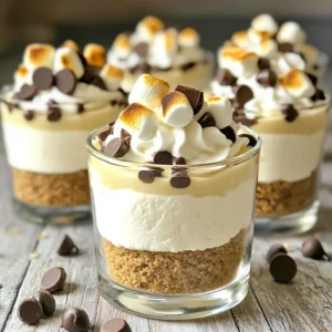 - 1 cup graham cracker crumbs - 4 tablespoons unsalted butter, melted - 8 oz cream cheese, softened - ½ cup powdered sugar - 1 teaspoon vanilla extract The base of our No-Bake S’mores Cheesecake Cups starts with graham cracker crumbs. These give a sweet and crunchy texture. Next, we add melted unsalted butter. This helps bind the crumbs and creates a rich flavor. Cream cheese is key for the cheesecake filling. It provides a creamy and smooth texture. Powdered sugar adds sweetness without grittiness. Don't forget the vanilla extract; it brightens the flavor and adds depth. - 1 cup whipped cream (or whipped topping) - ½ cup mini marshmallows - ½ cup chocolate chips (semi-sweet or milk chocolate) - Extra mini marshmallows and chocolate for garnish Toppings make this dessert fun and appealing. Whipped cream adds fluffiness and lightness. Mini marshmallows give that classic s'mores touch. Chocolate chips provide rich, melted chocolate goodness. For garnish, you can add extra mini marshmallows and chocolate pieces on top. - Mixing bowls - Serving cups or glasses - Kitchen torch (optional) You will need mixing bowls to combine your ingredients. Serving cups or glasses are perfect for layering your cheesecake. A kitchen torch is optional but fun for toasting the marshmallows on top. This adds a nice, smoky flavor that takes it to the next level. - Combine graham cracker crumbs and melted butter in a medium bowl. - Mix until the crumbs are evenly coated. This forms a tasty base for your cups. - Add the graham cracker mixture to your serving cups. - Press down gently to form a solid crust. This step is key for holding the layers above. - In a mixing bowl, beat together softened cream cheese and powdered sugar until smooth. - Mix in the vanilla extract for a fragrant touch. This adds great flavor to your cheesecake. - Gently fold in the whipped cream to the cream cheese mixture. - This makes the filling light and fluffy. Be careful not to deflate the mixture. - Spoon a layer of the cheesecake filling onto the graham cracker crust in each cup. - Top with mini marshmallows and some chocolate chips for sweetness. - Repeat layers until the cups are filled. This creates a delightful mix of flavors. - Refrigerate the cups for at least 3 hours or until set. - Before serving, you can torch the mini marshmallows for a toasted effect. - Garnish with extra chocolate pieces for a final touch. This will impress your guests! To make your cheesecake smooth, ensure the cream cheese is softened. It should feel like a cloud. If it is cold, your filling will be lumpy. This step is key for a creamy bite. Next, when you fold in the whipped cream, do it gently. This keeps the air in, making it light and fluffy. Over-mixing can make it dense, which we want to avoid. Using clear cups for your s'mores cheesecake cups adds a nice touch. Guests can see the layers, and it looks inviting. I also suggest serving with extra chocolate drizzle. A quick drizzle makes each bite feel special. You can use a squeeze bottle for precision. One common mistake is over-mixing the filling. This can lead to a heavy texture. Mix just until smooth. Another mistake is not chilling long enough. The cups need at least three hours to set. If you rush this step, the layers may run together. Trust the chill! {{image_2}} You can switch things up with fun flavors. A pumpkin spice version is perfect for fall. Just add pumpkin puree and some cinnamon to the cheesecake mix. It gives a warm, cozy taste. Another great choice is a peanut butter s'mores variation. Mix creamy peanut butter into the cheesecake filling. This adds a rich and nutty twist. You can even top it with chopped peanuts for extra crunch. If you need gluten-free options, use gluten-free graham crackers. They make a great base for the cheesecake. Just make sure to check the label for gluten-free labeling. For those who prefer vegan options, substitute cream cheese with vegan cream cheese. Many brands taste just as good. You can also use coconut whipped cream for a light and fluffy texture. You can enhance your cups with seasonal flavors. In summer, add fresh fruit layers like strawberries or blueberries. They bring a refreshing touch and vibrant color. During fall, consider adding dried fruits or nuts. Chopped pecans or cranberries make each bite even more delightful. The mix of flavors and textures will impress everyone. To keep your No-Bake S’mores Cheesecake Cups fresh, store them in the fridge. Use an airtight container to seal them tight. This helps to prevent any odors from your fridge affecting the taste. These cheesecake cups last for about 3 to 5 days in the fridge. Enjoy them within this time for the best taste and texture. After 5 days, they may not taste as fresh or creamy. You can freeze cheesecake cups, but it’s not the best choice. Freezing can change their creamy texture. If you still want to freeze, wrap each cup well in plastic wrap. Place them in a freezer-safe container. Thaw in the fridge before serving. To help your cheesecake set right, chill it well. I recommend at least 3 hours in the fridge. The longer it chills, the firmer it gets. Make sure to cover the cups with plastic wrap. This keeps moisture in and prevents the top from drying out. Yes, you can make these cups a day in advance. Just prepare and assemble them, then chill overnight. This gives the flavors time to meld. If you want, you can add the toppings just before serving. This keeps them fresh and tasty. You can use cookies, like digestive biscuits or vanilla wafers, for the crust. Crushed pretzels add a salty crunch. For a gluten-free option, try gluten-free graham crackers. Just crush them the same way and mix with melted butter. It's best to torch the marshmallows just before serving. This keeps them soft and fluffy. If you torch them too early, they may get hard and lose that nice toasted taste. You can just add extra marshmallows on top for a fun look. This recipe makes 6 to 8 cups, depending on cup size. For a good portion, fill each cup about three-quarters full. This way, everyone gets a nice treat without feeling too full. Perfect for sharing at a party! These cheesecake cups are easy to make and full of flavor. You learned about the key ingredients like graham crackers and cream cheese. The step-by-step guide helped you layer delicious flavors, while tips ensured a perfect texture. You can even try different variations to match your taste. Remember, these cups store well and can last a few days. With a little creativity, you can impress anyone with this treat. Enjoy making these delightful desserts, and let your kitchen be filled with joy!
