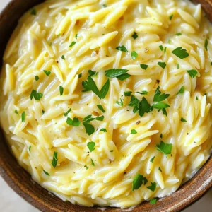 - 1 cup orzo pasta - 3 cups vegetable broth - 1 tablespoon olive oil - 3 cloves garlic, minced - 1 small shallot, finely chopped - 1 cup heavy cream - 1 cup grated Parmesan cheese - 1 teaspoon Italian seasoning - Salt and pepper to taste - Fresh parsley, chopped (for garnish) Creamy Garlic Parmesan Orzo uses simple, fresh ingredients. Each one adds a special taste. First, you need orzo pasta. This small pasta cooks quickly and absorbs flavors well. The vegetable broth adds depth that pairs nicely with the creamy sauce. Next, I use olive oil for cooking. It helps the garlic and shallots become fragrant and soft. Garlic brings a strong flavor, while shallots add a subtle sweetness. Together, they create a great base for the sauce. Heavy cream is key to making this dish rich and creamy. It blends with the Parmesan cheese, giving you that smooth texture. Parmesan cheese adds a nutty, salty taste. Italian seasoning brings an herb mix that enhances the overall flavor. Finally, salt and pepper are essential for balance. Don’t forget the fresh parsley! It adds a pop of color and freshness. Use it as a garnish for your dish. These ingredients come together to create a delicious meal that you can enjoy anytime. To start, you need to simmer the vegetable broth. Grab a medium saucepan and heat three cups of vegetable broth over medium heat. Watch it closely until it begins to simmer. This should take just a few minutes. Next, add one cup of orzo pasta to the simmering broth. Cook the orzo according to the package instructions, which usually takes about 8 to 10 minutes. You want it to be al dente, meaning it should still be slightly firm when you bite into it. Once cooked, drain the orzo and set it aside. Now, let's prepare the creamy sauce. In a large skillet, heat one tablespoon of olive oil over medium heat. Once hot, add three cloves of minced garlic and one small finely chopped shallot. Sauté these for about 3 to 4 minutes until they become fragrant and translucent. Next, reduce the heat to low. Stir in one cup of heavy cream and let it warm through. Make sure it doesn’t boil. After that, gradually whisk in one cup of grated Parmesan cheese. Continue whisking until it melts and the sauce turns creamy. Now it’s time to combine everything. Add the cooked orzo to the skillet with the creamy sauce. Toss the orzo until it is evenly coated in the sauce. Stir in one teaspoon of Italian seasoning, along with salt and pepper to taste. Let the orzo simmer on low heat for a couple of minutes. This allows all the flavors to meld together beautifully. When done, serve it warm, garnished with freshly chopped parsley. Enjoy your creamy garlic Parmesan orzo! To make a creamy sauce, whisk the Parmesan cheese well. This step helps it melt smoothly. If you skip this, the cheese can clump together. To avoid curdling, keep the heat low when adding the cream. High heat can cause the cream to break down, ruining the texture. Always choose quality ingredients for the best flavor. Fresh garlic and a good brand of Parmesan make a huge difference. You can also add herbs like thyme or rosemary. A pinch of red pepper flakes can add a nice kick. Experiment with spices to find your favorite mix. Creamy garlic Parmesan orzo pairs well with proteins like chicken or shrimp. It also works great with roasted vegetables. For side dishes, consider a fresh salad or steamed broccoli. These options balance the richness of the orzo and create a complete meal. {{image_2}} You can easily change up the protein in this dish. Adding chicken or shrimp makes it heartier. Just cook them in the skillet before the garlic and shallot. This adds rich flavor to the creamy sauce. For a vegetarian option, try adding cooked mushrooms or chickpeas. Both add texture and protein without meat. Want to mix it up? You can use different types of cheese. Try gouda or feta for a unique twist. They add new flavors that blend well with garlic. You can also add extra vegetables to boost nutrition. Spinach, peas, or roasted red peppers work great. Just toss them in with the orzo for a colorful dish. If you need gluten-free options, look for gluten-free orzo. Many brands offer a tasty pasta made from rice or corn. For dairy-free needs, use coconut cream instead of heavy cream. Nutritional yeast can also replace Parmesan cheese. This helps keep the dish creamy and flavorful. To store leftovers, let the orzo cool down. Place it in an airtight container. Make sure to cover the container well. This helps keep it fresh. You can store it in the fridge for up to three days. When it comes time to eat, reheat it on the stove. Add a splash of broth or cream to keep it creamy. Heat over low until warm. Stir often to prevent sticking. To freeze Creamy Garlic Parmesan Orzo, first let it cool completely. Then, scoop it into a freezer-safe bag. Squeeze out as much air as possible. This helps prevent freezer burn. Label the bag with the date. You can freeze it for up to three months. When you’re ready to eat, take the bag from the freezer. Let it thaw overnight in the fridge. After thawing, reheat it in a skillet. Add a little broth or cream to bring back the creaminess. Heat it slowly, stirring often, until hot. Enjoy your meal! Creamy Garlic Parmesan Orzo lasts about 3 to 5 days in the fridge. Store it in an airtight container. Make sure it cools down before putting it away. This helps keep it fresh. If you want to enjoy it later, check for any signs of spoilage before eating. Yes, you can make Creamy Garlic Parmesan Orzo ahead of time. Prepare it as normal and let it cool. Then, store it in the fridge for up to 5 days. When you want to eat it, just reheat in a pan. Add a splash of broth or cream to bring back the creaminess. This makes meal prep easy and quick! If you need a substitute for Parmesan, try Pecorino Romano. It adds a similar salty flavor. Nutritional yeast is another great option for a dairy-free choice. You can also use grated Grana Padano or Asiago cheese. Each option will give a unique taste, so choose what you like best. This blog post shared how to make Creamy Garlic Parmesan Orzo. You learned about the main ingredients and the step-by-step cooking process. We also covered tips for getting the perfect texture and flavor. Plus, I shared variations to fit different diets. By following these steps, you're set to create a delicious dish. Enjoy making this orzo dish for family or friends! Simple ingredients can lead to great meals.