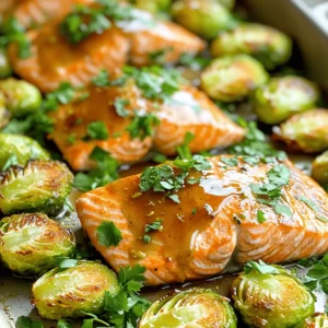 - 4 salmon fillets (6 oz each) - 2 cups Brussels sprouts, halved - 1/4 cup maple syrup - 2 tablespoons Dijon mustard - 2 tablespoons olive oil - 1 tablespoon fresh lemon juice - 2 cloves garlic, minced - Salt and pepper to taste - 1 teaspoon dried thyme - 1/2 teaspoon paprika - Fresh parsley for garnish (optional) Gather these ingredients before you start cooking. The salmon and Brussels sprouts are the stars here. They bring great flavors and health benefits. The maple syrup adds sweetness, while Dijon provides a nice tang. Fresh lemon juice brightens the dish, and garlic gives it depth. Using olive oil helps the veggies roast well. The thyme and paprika add warmth and aroma. You can skip the parsley if you don't have it. But it adds a nice touch at the end. By prepping these ingredients, you set yourself up for a smooth cooking experience. Trust me; this dish will impress you and anyone you serve it to! - Preheat the oven to 400°F (200°C). This helps cook the salmon evenly. - Line a large baking sheet with parchment paper. It makes for easy cleanup later. - In a small bowl, whisk together the maple syrup, Dijon mustard, olive oil, lemon juice, minced garlic, salt, pepper, thyme, and paprika. - This mixture will add a sweet and tangy flavor to your dish. - Place the salmon fillets on one side of the prepared baking sheet. Season each fillet with a pinch of salt and pepper. - Brush the salmon fillets generously with the marinade. Make sure they are well coated for the best flavor. - Take the halved Brussels sprouts and toss them in the remaining marinade. This will add great taste. - Spread the Brussels sprouts out on the other side of the baking sheet, cut side down. - Roast in the preheated oven for about 15-20 minutes. - Check for doneness by seeing if the salmon flakes easily with a fork. The Brussels sprouts should be tender and caramelized. To ensure even cooking of the salmon and Brussels sprouts, place them on the baking sheet with space between them. This helps hot air circulate. Keep an eye on the roasting time. Aim for about 15-20 minutes. The salmon should flake easily with a fork, and the Brussels sprouts should be tender and slightly caramelized. Pair this dish with rice or quinoa. Both add a nice texture to the meal. They also soak up the maple Dijon sauce well. For a fresh touch, serve lemon wedges alongside. A squeeze of lemon brightens the flavors. Fresh herbs like parsley or chives add color and flavor. A sprinkle of citrus zest can enhance the dish too. For a tasty crunch, consider adding some toasted nuts. They provide a nice contrast to the soft salmon and sprouts. {{image_2}} You can easily switch out the main ingredients if you want. Try using another fish like trout or cod instead of salmon. If you prefer a plant-based option, tofu works great too. For a change in veggies, replace Brussels sprouts with asparagus or green beans. Both options add a fresh twist. The sauce can also change to suit your taste. Instead of Dijon mustard, use whole grain mustard for a whole new flavor. If you like sweetness, honey mustard is a good choice. You can also add spices like cayenne or cumin for some heat. This small change can make a big difference. Want to jazz up this dish? Add citrus slices, like lemon or orange, to the baking sheet. The juice will soak into the salmon and veggies, adding brightness. You can also toss in nuts or seeds for a crunchy texture. Almonds or sunflower seeds are excellent choices. They give a nice contrast to the soft salmon and Brussels sprouts. Store leftovers in an airtight container. This keeps the salmon and Brussels sprouts fresh. They can last in the fridge for up to three days. When storing, try to keep the salmon on top. This prevents the sprouts from getting mushy. To freeze cooked salmon, let it cool first. Place it in a freezer-safe bag. Squeeze out as much air as you can before sealing. For Brussels sprouts, freeze them in a separate bag. They should last for up to three months. When you want to eat them, thaw them overnight in the fridge. Reheat salmon and Brussels sprouts in the oven for the best taste. Preheat the oven to 350°F (175°C). Place them on a baking sheet and cover with foil. Heat for about 10-15 minutes. This keeps them moist. If using the microwave, heat in short bursts. Check every 30 seconds to avoid overcooking. This way, you keep the flavor and texture just right. You can tell when salmon is cooked by looking for a few signs. The flesh will change color from bright pink to a lighter, opaque pink. It should also flake easily with a fork. If you have a thermometer, the internal temperature should reach 145°F (63°C). This means it is safe to eat and will be nice and moist. Yes, you can use frozen salmon! Just make sure to thaw it first. You can do this by placing it in the fridge overnight or using a quick method under cold running water. Frozen salmon may release more water while cooking, so check the doneness carefully. It might take a few extra minutes to cook compared to fresh salmon. This dish pairs well with various sides. Here are some ideas: - Rice or quinoa for a filling base - A simple green salad for freshness - Mashed potatoes for comfort - Roasted sweet potatoes for a sweet touch Yes, this recipe is healthy! Salmon is rich in omega-3 fatty acids, which are great for heart health. Brussels sprouts are high in fiber, vitamins, and minerals. They can help boost your immune system. The use of olive oil adds healthy fats, making this a balanced meal. Enjoy it guilt-free! This recipe for salmon and Brussels sprouts combines tasty ingredients for a rewarding dish. Prepping the marinade and roasting the veggies are key steps for flavor. You can even adjust the recipe with different ingredients or toppings to match your taste. Enjoy the meals you create and share them with loved ones. Keep trying new ideas and have fun in the kitchen!