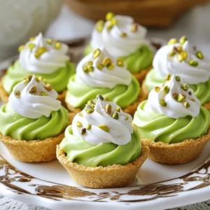 To make these tasty pistachio cream pie cups, you need: - 1 cup unsalted pistachios (shelled, divided) - 1 cup heavy whipping cream - ½ cup powdered sugar - 1 teaspoon vanilla extract - 8 oz cream cheese, softened - ½ cup Greek yogurt - ¼ cup milk - ½ teaspoon almond extract - 8 mini graham cracker pie crusts or 2 cups crushed graham crackers mixed with 4 tablespoons melted butter - Whipped cream (for topping) - Additional pistachios for garnish You can adjust this recipe easily. If you want a nut-free version, try using a cookie crust. You can replace heavy cream with coconut cream for a dairy-free option. If you need a lower sugar option, use a sugar substitute in place of powdered sugar. For more flavor, consider adding a splash of orange or lemon zest. Gather these tools for success: - Food processor for grinding pistachios - Mixing bowls for blending ingredients - Hand mixer or whisk for whipping cream - Spoon or piping bag for filling the cups - Measuring cups and spoons for accuracy - Mini graham cracker pie crusts or a baking pan if making your own crust These items help you create the best pistachio cream pie cups. Enjoy the process and let your creativity shine! To start, take one cup of unsalted pistachios and shelve them. You will use half for this recipe. Place the shelled nuts in a food processor. Pulse until they are finely ground but not powdery. This texture adds a nice crunch. Set these ground pistachios aside for later use. Next, grab a mixing bowl and add 8 ounces of softened cream cheese. Then, add ½ cup of Greek yogurt, ¼ cup of milk, and ½ teaspoon of almond extract. Use a hand mixer or a whisk to blend these ingredients. Mix until you achieve a smooth and creamy texture. This base will be rich and flavorful. In a separate bowl, pour in 1 cup of heavy whipping cream. Whip it until soft peaks form. This step is crucial for a light texture. Gradually add ½ cup of powdered sugar and 1 teaspoon of vanilla extract. Continue whipping until the cream holds stiff peaks. This will give your cups a fluffy feel. Now, it's time to bring everything together. Gently fold the ground pistachios into the cream cheese mixture. Make sure it is well combined. After that, carefully fold in the whipped cream. This keeps the mixture airy. Spoon or pipe this delicious mixture into mini graham cracker pie crusts, filling each until just above the edge. For the final touch, top each cup with whipped cream. You can pipe or dollop it on. Next, sprinkle additional coarsely chopped pistachios on top for extra crunch and decoration. For a nice presentation, chill the cups in the fridge for at least 2 hours. This helps the flavors blend and the texture set. Enjoy your delightful pistachio cream pie cups! To make perfect whipped cream, start with very cold heavy cream. Cold cream whips faster and gets thicker. Use a chilled bowl and beaters for best results. Begin whipping on low speed, then increase to medium-high. Add powdered sugar gradually. This helps sweeten without clumping. Whip until stiff peaks form. This means the cream holds its shape when you lift the beaters. Keep an eye on it to avoid over-whipping, which can turn it grainy. You can get creative with flavors in your pistachio cream pie cups. Try adding a splash of orange zest or lemon juice for a fresh taste. You can also mix in a bit of chocolate syrup for a rich twist. If you love caramel, drizzle some over the top before serving. For a nutty kick, add crushed almonds or walnuts with the pistachios. Each variation can bring a unique twist to your delicious treat. One common mistake is not fully softening the cream cheese. If it’s too cold, it won’t blend well, leading to lumps. Another mistake is over-whipping the cream. This can make it too thick and hard. Also, don’t skip chilling the cups before serving. This step helps the flavors meld and improves the texture. Finally, be careful with the crust. If it’s too loose, it won’t hold the filling well. Use a firm crust for best results. {{image_2}} You can switch up the crust for more fun. Try using chocolate cookie crusts instead of graham crackers. This adds a rich flavor that pairs well with pistachios. If you're feeling adventurous, use crushed nuts mixed with melted butter for a nutty base. Almond or hazelnut crusts can give a tasty twist too. Mix in extra flavors for a unique treat. Add melted chocolate to the cream mixture for a chocolate pistachio pie. You can also fold in fresh fruit like diced strawberries or raspberries for a fruity kick. If you like spice, try a hint of cinnamon or cardamom. It gives a warm touch to your cups. The fun doesn't stop with the filling! You can top your cups with whipped cream for a classic look. Add a drizzle of chocolate sauce for extra sweetness. Fresh fruit can brighten the presentation and flavor. Don't forget to sprinkle more chopped pistachios on top for a crunchy finish! To keep your pistachio cream pie cups fresh, store them in the fridge. Place them in an airtight container. This helps maintain their taste and texture. They can last for about four days in the fridge. Avoid leaving them out at room temperature for too long. You can freeze these cups if you want to save some for later. First, let them set in the fridge. Then, wrap each cup tightly in plastic wrap. Place them in a freezer-safe container or bag. They will stay fresh in the freezer for up to two months. To enjoy, just take them out and let them thaw in the fridge overnight. Once chilled, serve the cups cold for the best taste. You can add extra whipped cream and pistachio pieces on top. This adds a nice crunch. For a fun twist, try adding a sprig of mint for color. These small touches can make your dessert look impressive. Yes, you can use salted pistachios. However, it may change the taste. The salt can balance the sweetness of the cream. If you prefer a sweeter treat, stick with unsalted pistachios. This way, the flavors stay bright and fresh. These cups stay fresh for about three days in the fridge. Make sure to cover them well with plastic wrap or a lid. This will keep them from drying out or absorbing other smells. The longer they sit, the softer the crust may get. Absolutely! You can make these cups a day in advance. Just store them in the fridge. This allows the flavors to blend nicely. Plus, it saves you time on the day of your event or gathering. Yes, you can make a vegan version. Replace cream cheese with vegan cream cheese. Use coconut cream instead of heavy cream. For the yogurt, choose a plant-based yogurt. Lastly, make sure your crust is dairy-free. This way, everyone can enjoy these tasty cups! You now have all you need to make delicious pistachio cream pie cups. We covered the key ingredients and measurements. You learned essential tools and step-by-step instructions to create the perfect dessert. I shared tips to help you avoid common mistakes. Variations give you fun ways to make it your own. Finally, proper storage will ensure freshness. Experiment with flavors and enjoy sharing these treats. Happy baking!