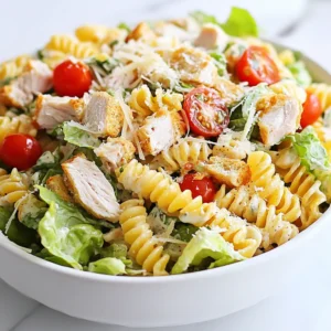 To make a tasty Chicken Caesar Pasta Salad, you need these key ingredients: - 2 cups rotini pasta - 1 cup cooked chicken breast, diced - 1 cup romaine lettuce, chopped - ½ cup cherry tomatoes, halved - ¼ cup grated Parmesan cheese - 2 tablespoons Caesar dressing - 2 tablespoons Greek yogurt - 1 tablespoon lemon juice - Salt and black pepper, to taste - ¼ cup croutons (for garnish) These ingredients blend well to create a fresh and creamy salad. You can add more flavor and texture with these optional ingredients: - Sliced olives for a briny touch - Avocado for extra creaminess - Cooked bacon bits for a smoky crunch - Red onion slices for a bit of bite - Fresh herbs like basil or parsley for brightness Feel free to mix and match based on your taste. If you don't have some ingredients, here are easy swaps: - Use penne pasta instead of rotini. - Swap grilled chicken for rotisserie chicken. - Replace romaine with spinach or kale. - Use any cheese if you lack Parmesan, like feta or mozzarella. - You can substitute Caesar dressing with ranch or Italian dressing. These swaps will still keep your salad delicious and satisfying. {{ingredient_image_1}} First, cook 2 cups of rotini pasta. Follow the package instructions. Aim for al dente, so it stays firm. Once cooked, drain the pasta and rinse it under cold water. This step cools it down quickly. It also helps prevent sticking. Set the pasta aside while you prepare the other ingredients. Next, gather your chicken and veggies. Use 1 cup of cooked chicken breast and dice it into bite-sized pieces. In a large bowl, add the chicken, 1 cup of chopped romaine lettuce, and ½ cup of halved cherry tomatoes. This mix adds color and crunch to your salad. Now, let’s make the dressing. In a small bowl, whisk together 2 tablespoons of Caesar dressing, 2 tablespoons of Greek yogurt, and 1 tablespoon of lemon juice. Add salt and black pepper to taste. Whisk until smooth. This dressing gives the salad a creamy and tangy flavor. Add the cooled pasta to the large bowl with the chicken and veggies. Pour the dressing over the top. Gently toss everything together until well mixed. You want each piece to be coated in dressing. Then, sprinkle in ¼ cup of grated Parmesan cheese and toss lightly again. This adds a nice cheesy flavor. When ready to serve, taste the salad. Adjust the seasoning if needed. For a crunchy finish, top it with ¼ cup of croutons. Serve the salad in a large bowl or on individual plates. You can garnish with extra Parmesan cheese and a few whole cherry tomatoes for a nice look. Enjoy your delicious Chicken Caesar Pasta Salad! To get a creamy texture, use both Caesar dressing and Greek yogurt. The yogurt adds a nice tang. Mix them well in a bowl before adding to the salad. This helps blend the flavors together. If you want it creamier, add more yogurt. Just be careful not to overdo it! When tossing your salad, be gentle. You want to mix the pasta and veggies without crushing them. Start by adding the dressing to the pasta first. Then, add the veggies and chicken. Use two large spoons or forks to lift and fold the ingredients. This keeps everything intact and helps coat every piece. If you want to make this salad lighter, swap out some dressing for more yogurt. For a vegan version, use tofu instead of chicken and plant-based dressing. You can also add more veggies like bell peppers or cucumbers for crunch. Adjust the cheese or leave it out for a dairy-free option. Pro Tips Cook Pasta Al Dente: To ensure the pasta retains its shape and texture, cook it until al dente. This means it should be firm to the bite but not hard. Chill Ingredients: For a refreshing taste, chill your chicken and vegetables before mixing. This will enhance the overall flavor of the pasta salad. Dress Just Before Serving: To avoid sogginess, add the dressing to the salad just before serving. This keeps the ingredients crisp and fresh. Customize Your Greens: Feel free to mix in other greens like spinach or kale for added nutrition and flavor. This adds variety to your salad! {{image_2}} To make a vegetarian version, skip the chicken. Instead, use chickpeas or tofu for protein. Both options are filling and tasty. You can also add more veggies like bell peppers or cucumbers. These add color and crunch to your salad. Don't forget to keep the Caesar dressing, as it adds great flavor. If you need a gluten-free option, switch out the rotini pasta. Use gluten-free pasta made from rice or corn. These pastas work well and taste great. You can also use spiralized zucchini for a fresh twist. Just make sure any dressing you use is gluten-free too. To give this salad extra flavor, try adding some fresh herbs. Chopped basil or parsley works well with the dish. You can also toss in some olives or capers for a briny taste. For a bit of heat, add red pepper flakes. This will spice things up without overpowering the dish. To keep your Chicken Caesar Pasta Salad fresh, place it in an airtight container. Make sure to cover it well. You can store it in the fridge for later meals. This helps to keep the flavors intact and the pasta from getting mushy. Try to consume it within three days for the best taste. Reheating pasta salad can be tricky. I suggest eating it cold for the best flavor. If you prefer it warm, heat it gently in a pan. Add a bit of olive oil or extra dressing to keep it moist. Avoid using the microwave, as it can make the pasta soggy. Chicken Caesar Pasta Salad can last in the fridge for three to four days. If you notice any off smells or changes in texture, it’s best to toss it out. For longer storage, consider freezing the salad without the dressing. It can last in the freezer for up to two months, but the texture may change when thawed. Yes, you can make Chicken Caesar Pasta Salad ahead of time. This dish tastes great cold. I suggest making it a few hours before serving. Just keep it in the fridge. The flavors mix well when it sits. Absolutely! You can add any veggies you like. Bell peppers, cucumbers, or spinach work well too. Just chop them up small. Mix them in at the same time as the other veggies. This makes the salad even more colorful and tasty. If you want a change, try ranch or Italian dressing. Both add a nice flavor. You can also use a yogurt-based dressing for a lighter option. Just make sure it matches the taste you want. To make a lighter version, use less dressing. You can replace some dressing with extra Greek yogurt. This keeps it creamy but cuts down on calories. You can also use whole wheat pasta for more fiber. This blog post covered the essentials for making a Chicken Caesar Pasta Salad. We outlined the main ingredients, with options for substitutions and enhancements. You learned step-by-step instructions for cooking each part, and tips to achieve the perfect creamy texture. We also explored variations, storage, and answered common FAQs. Embrace your creativity in the kitchen. Experiment with flavors, make it your own, and enjoy every bite.