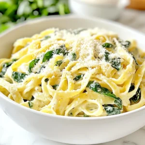 For this tasty dish, you will need: - 12 oz fettuccine pasta - 4 cups fresh spinach, roughly chopped - 2 tablespoons olive oil - 3 cloves garlic, minced - 2 cups vegetable broth - 1 cup heavy cream - 1 cup grated Parmesan cheese - Salt and pepper to taste - ¼ teaspoon nutmeg (optional) - Red pepper flakes for garnish (optional) These ingredients blend to create a rich and creamy meal that everyone loves. You can add a few extras to enhance the dish: - A pinch of red pepper flakes for heat - Fresh herbs like basil or parsley for freshness - Chicken or shrimp for added protein These options can change the dish's flavor to fit your taste. To make this recipe, gather these tools: - A large pot for cooking - A wooden spoon for stirring - Measuring cups for accuracy - A grater for the Parmesan cheese Having these items will help you cook smoothly and enjoyably. {{ingredient_image_1}} Start by gathering all your ingredients. You need fettuccine, spinach, olive oil, garlic, vegetable broth, heavy cream, and Parmesan cheese. Don’t forget salt, pepper, and nutmeg if you like. Heat the olive oil in a large pot over medium heat. Add the minced garlic and sauté for about one minute. The smell will be amazing! Next, add your fettuccine pasta to the pot. Pour in the vegetable broth and stir it all together. Bring the broth to a boil. Once it boils, lower the heat and let it simmer. Cover the pot and cook for about 10 to 12 minutes. Stir the pasta occasionally to keep it from sticking. You want the pasta to be al dente, which means it should still have a little bite. Once the pasta is cooked, it’s time to create the sauce. Stir in the heavy cream and grated Parmesan cheese. Mix well until the cheese melts and the sauce becomes creamy. This is where the magic happens! The sauce will cling to the pasta and taste delicious. Now, add in the chopped spinach gradually. Stir until the spinach wilts and mixes well with the pasta. Season with salt, pepper, and nutmeg if you’re using it. Cook for one to two more minutes to heat everything through. After that, remove the pot from the heat. Let it sit for a minute to thicken. Serve your dish hot. If you like some spice, sprinkle red pepper flakes on top for garnish! To cook fettuccine just right, start with boiling water. Use a large pot for best results. Add a pinch of salt to the water. This adds flavor as the pasta cooks. Stir the pasta often to prevent it from sticking. Cook it until it's al dente, which means firm but not hard. This usually takes about 10-12 minutes. Always check the package for exact times. Once done, drain the pasta quickly, but save some pasta water. It can help adjust the sauce later. To get that perfect creamy sauce, timing is key. Add the heavy cream after the pasta is cooked. This keeps the sauce smooth and rich. Stir in grated Parmesan cheese right after the cream. The heat will melt the cheese and make the sauce thick. If it’s too thick, use that saved pasta water. Just add a little at a time. Nutmeg adds a warm flavor, but it’s optional. Make sure to mix everything well for the best texture. To boost flavor, garlic is a must. Sauté it in olive oil until fragrant. You can also add a pinch of red pepper flakes for heat. Fresh herbs like basil or parsley add freshness and color. If you want a deeper taste, consider adding lemon zest. It brightens the dish and balances the creaminess. Always taste your dish before serving. Adjust salt and pepper as needed to make it perfect. Pro Tips Choose Fresh Spinach: Using fresh spinach instead of frozen will enhance the flavor and texture of the dish. Fresh spinach wilts beautifully and retains more nutrients. Adjust Creaminess: If you prefer a lighter sauce, you can substitute half of the heavy cream with additional vegetable broth. This will still keep the dish creamy without being too rich. Perfectly Cooked Pasta: To ensure your fettuccine is perfectly cooked, taste it a minute or two before the recommended cooking time. You want it al dente—firm to the bite. Garnish Wisely: A sprinkle of red pepper flakes adds a nice kick to the dish. Consider serving with additional Parmesan cheese for extra flavor and presentation. {{image_2}} You can easily add protein to your One-Pot Alfredo Spinach Pasta. Try cooked chicken, shrimp, or sausage. Just sauté them before adding the garlic. For a quick option, use rotisserie chicken. This step adds flavor and makes the dish heartier. For a vegetarian twist, use plant-based cream and cheese. Cashew cream works well for a creamy texture. You can also use nutritional yeast in place of Parmesan. These swaps keep the dish rich while making it suitable for vegans. Feel free to swap in seasonal veggies. During spring, add peas or asparagus. In the fall, try butternut squash or mushrooms. Using seasonal ingredients not only enhances flavor but also adds nutrients. You can mix and match based on what you have at home. You can store your One-Pot Alfredo Spinach Pasta in the fridge. Place it in an airtight container. It will stay fresh for about 3 to 4 days. Make sure it cools down before sealing. This keeps the pasta from getting soggy. If you want to save leftovers for later, freezing is a great option. First, let the pasta cool completely. Then, transfer it to a freezer-safe container. It can last in the freezer for up to 2 months. When you're ready to eat, just thaw it in the fridge overnight. To reheat your pasta, you can use the stove or the microwave. If using the stove, add a splash of broth or cream. Heat it over low heat, stirring often. For the microwave, place it in a bowl and cover it. Heat in short bursts, stirring between, until warm. This helps keep the pasta creamy and delicious. You can use half-and-half instead of heavy cream. This will make the dish lighter. You can also try coconut milk for a dairy-free option. It adds a nice flavor too. If you want a thicker sauce, blend silken tofu. This works well and keeps the dish creamy. Yes, you can use any pasta you like. Penne or rotini are great choices. They hold the sauce well. Even spaghetti works if you prefer it. Just keep an eye on the cooking time. Different shapes may take longer or shorter to cook. You can add kale or arugula along with spinach. Both add great flavor and nutrition. Broccoli florets or peas also work well. Just add them at the same time as the spinach. They will cook quickly and stay bright green. This recipe is perfect for meal prep. It keeps well in the fridge for a few days. Just store it in an airtight container. When ready to eat, heat it in a pan or microwave. You may need to add a splash of broth or cream to loosen it up. You learned how to make One-Pot Alfredo Spinach Pasta. We covered main and optional ingredients, equipment, and detailed steps. Tips for cooking pasta and making a creamy sauce help you succeed. Variations let you switch proteins or try vegan options. Plus, we shared storage and reheating info. Now, you can enjoy a delicious meal that’s easy to prepare and customize. I hope this recipe brings joy to your kitchen!
