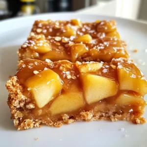 - 2 cups all-purpose flour - 1 cup rolled oats - ½ cup unsalted butter, softened - 3 medium apples, peeled, cored, and diced The main ingredients create the base of the bars. Flour and oats form a crumbly crust. The softened butter adds richness. Apples bring a sweet and tart flavor, while their texture contrasts well with the base. - ½ cup brown sugar - ¼ cup granulated sugar - 1 teaspoon vanilla extract - 1 teaspoon cinnamon These sweeteners enhance the taste of the bars. Brown sugar gives a deep, caramel-like flavor. Granulated sugar adds sweetness. Vanilla extract brings warmth, and cinnamon adds a cozy spice. Together, they create a rich flavor profile. - 1 cup caramel sauce (store-bought or homemade) - ½ teaspoon sea salt (for sprinkling) Caramel sauce is the star of this recipe. It adds a sweet, gooey layer that pairs perfectly with apples. A sprinkle of sea salt balances the sweetness. This touch of salt makes each bite even more delicious. {{ingredient_image_1}} - Preheat the oven to 350°F (175°C). - Grease and line a 9x13 inch baking pan with parchment paper. Start by heating your oven. This ensures even cooking. Next, prepare your baking pan. Greasing it helps the bars come out easily. The parchment paper adds extra help. Leave some paper hanging over the sides. This makes it easier to lift the bars out later. - Whisk together flour, oats, baking soda, and salt. - Cream together butter, brown sugar, and granulated sugar until fluffy. - Combine wet and dry ingredients and prepare the base layer. In a bowl, combine the flour, oats, baking soda, and salt. This mix gives your bars texture. Next, beat the softened butter with sugars until fluffy. This step adds air, making the dough light. Add an egg and vanilla to the butter. Mix until everything is combined. Gradually stir in your dry mix. Be gentle; overmixing can make the bars tough. - Press the base layer into the baking pan. - Toss apples with cinnamon and layer over the crust. - Drizzle caramel sauce and top with remaining oat mixture. Take half of your dough and press it into the pan. This forms a solid base. Chop the apples and toss them in cinnamon. Spread the apple mix over the dough. Drizzle half of the caramel sauce on top. This adds a sweet layer. Finally, sprinkle the remaining dough over everything. - Bake for 25-30 minutes until golden brown. - Cool and drizzle with remaining caramel and sprinkle sea salt. Now, place your pan in the oven. Bake for 25 to 30 minutes. Look for a golden brown top. This shows the bars are ready. Once baked, let them cool for about 15 minutes. Drizzle with more caramel and sprinkle sea salt before serving. Not overmixing is key to soft and chewy bars. Overmixing can make them tough. Mix the dough until just combined. When checking doneness, look for a golden top. Insert a toothpick; it should come out clean or with a few crumbs. To elevate the taste, consider adding a pinch of nutmeg. This spice pairs well with apples and caramel. You can also add bittersweet chocolate chips for extra richness. The chocolate will add a lovely contrast to the sweet caramel. For a beautiful presentation, serve the bars on a wooden platter. Drizzle extra caramel sauce on top and sprinkle with sea salt. This adds an appealing look and more flavor. Pair the bars with vanilla ice cream or whipped cream. This will enhance the dessert experience and add creaminess. Pro Tips Use Fresh Apples: For the best flavor, use a mix of tart and sweet apples like Granny Smith and Honeycrisp. Make Your Own Caramel: Homemade caramel sauce can enhance the flavor and allows you to control the sweetness. Don’t Overmix: When combining wet and dry ingredients, mix just until combined to keep the bars tender. Cool Completely: Allow the bars to cool completely before cutting to ensure clean, even squares. {{image_2}} You can make these bars fit your needs with simple swaps. For gluten-free bars, use almond flour or gluten-free oats. This still gives you a great taste and texture. If you want a vegan option, swap the butter for plant-based butter. You can also use an egg replacer like flaxseed meal or applesauce. These changes make the recipe friendly for many diets. To add a twist, think about adding nuts. Pecans or walnuts fit nicely in these bars. They add crunch and flavor. You can also try different fruits. Pears or peaches will work well if you want a change from apples. Each fruit adds its own unique taste. Homemade caramel sauce is easy to make and tastes great. Just cook sugar and water until it turns golden. You can then stir in cream and butter to make it rich. If you choose store-bought caramel, look for brands that use real ingredients. This will keep the flavor fresh and tasty. Always check the label for quality. To keep your salted caramel apple bars fresh, store them in an airtight container. I recommend using glass or plastic containers with tight-fitting lids. This keeps moisture out and helps the bars stay soft. You can also wrap them tightly in plastic wrap. In the fridge, these bars last up to a week. If you want to keep them longer, freezing is a great option. Freezing your salted caramel apple bars is easy. Follow these steps: 1. Cool Completely: First, let the bars cool all the way in the pan. This step is key. 2. Cut and Wrap: Once cool, cut the bars into squares. Wrap each square tightly in plastic wrap. 3. Use a Freezer Bag: Place the wrapped bars in a freezer-safe bag or container. Label it with the date. This helps you know how long they’ve been in the freezer. To thaw, simply move the bars to the fridge overnight. This way, they regain their soft texture. If you want them warm, you can heat them in the microwave for a few seconds. Enjoy your tasty treat! Yes, you can make salted caramel apple bars ahead of time. I suggest making them a day before you plan to serve. After they cool, wrap them well in plastic wrap. Store them in the fridge. This way, the flavors blend nicely. For the best flavor and texture, choose firm apples. I recommend using Granny Smith, Honeycrisp, or Fuji apples. These apples hold their shape and add a nice tartness. You will love the contrast with the sweet caramel. To make homemade caramel sauce, follow these steps: 1. In a saucepan, melt 1 cup of sugar over medium heat. 2. Stir constantly until it melts and turns amber. 3. Slowly add ½ cup of heavy cream while stirring. 4. Remove from heat and add a pinch of salt. For a complete recipe, check out my caramel sauce guide. Yes, you can serve these bars warm. They taste great fresh from the oven. Just let them cool for about 15 minutes before cutting. This allows the caramel to set slightly. If you prefer them cooled, that is fine too! These salted caramel apple bars combine simple ingredients and easy steps. We discussed choosing the right apples, achieving a perfect texture, and storage tips. You can even try variations like gluten-free or vegan options. These bars are a delightful treat that’s both versatile and easy to make. Enjoy sharing them with friends and family, or savor them alone. With a little creativity, you can make this recipe your own. Get baking and enjoy delicious moments!