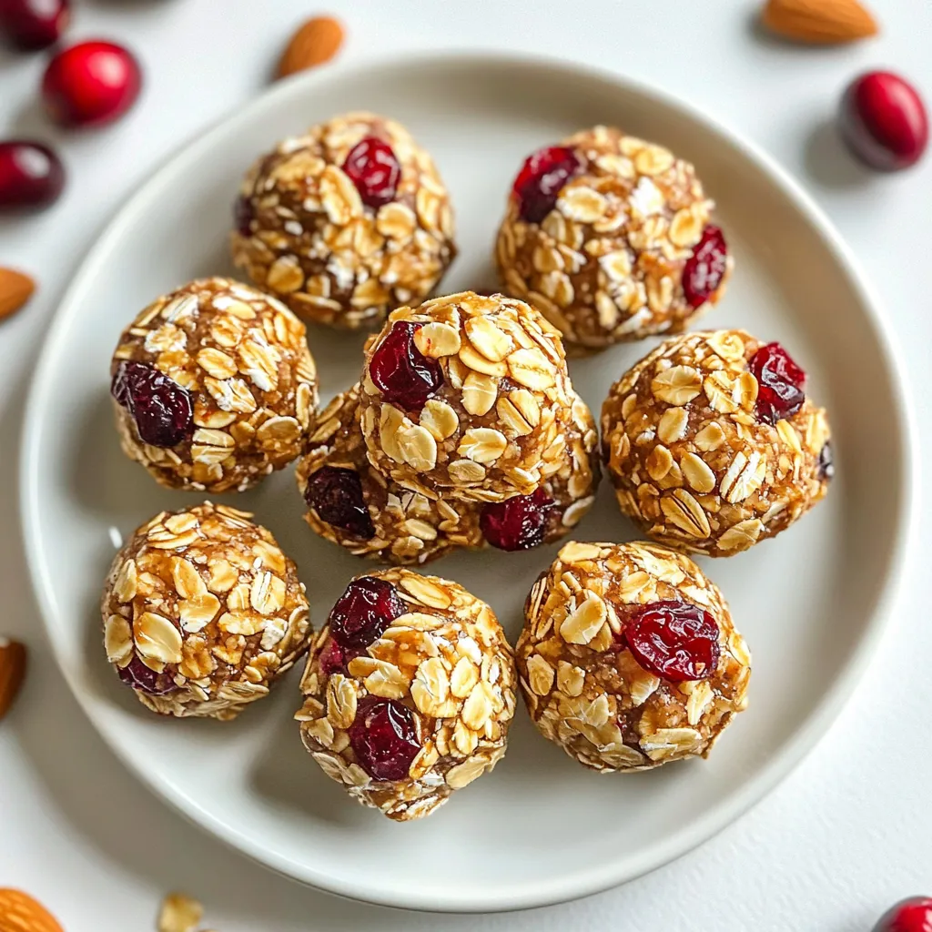 Cranberry almond energy bites are simple to make and need just a few key ingredients. Here’s what you will need: - 1 cup rolled oats - ½ cup almond butter - ½ cup honey or maple syrup - ½ cup dried cranberries, chopped - ¼ cup slivered almonds - ¼ cup chia seeds - 1 teaspoon vanilla extract - Pinch of sea salt Each ingredient serves a purpose and adds value to your snack. Let’s break it down: - Rolled oats: They offer fiber and keep you full longer. - Almond butter: This adds healthy fats and protein, which help build muscle. - Honey or maple syrup: These natural sweeteners give a quick energy boost. - Dried cranberries: They are rich in antioxidants and add a touch of sweetness. - Slivered almonds: These nuts provide crunch and are good for heart health. - Chia seeds: They are tiny powerhouses of omega-3s and fiber. - Vanilla extract: It enhances flavor and makes the bites more enjoyable. - Sea salt: A pinch helps balance the sweetness and enhances flavor. If you are missing an ingredient, don’t worry! Here are some easy swaps: - Rolled oats: Try quick oats or even ground oats if needed. - Almond butter: Use peanut butter or sun butter for nut-free options. - Honey or maple syrup: Agave syrup or brown rice syrup can work too. - Dried cranberries: Raisins or chopped dates can replace cranberries. - Slivered almonds: Chopped walnuts or pecans can add a different crunch. - Chia seeds: Flaxseeds can be a good alternative. - Vanilla extract: Almond extract can give a different flavor twist. - Sea salt: Regular table salt can be used if you have no sea salt. These changes can help you customize your energy bites to fit your tastes and needs! {{ingredient_image_1}} Making Cranberry Almond Energy Bites is simple. First, gather all your ingredients. You will need rolled oats, almond butter, honey or maple syrup, chopped dried cranberries, slivered almonds, chia seeds, vanilla extract, and a pinch of sea salt. This step takes about five minutes. In a large mixing bowl, combine the rolled oats, almond butter, and honey (or maple syrup). Use a spoon to stir them until the mix is smooth. Next, add the chopped dried cranberries, slivered almonds, chia seeds, vanilla extract, and sea salt. Mix everything together until you have a sticky mixture. This should take about five minutes. Now it’s time to shape the bites. Use your hands to scoop out small portions of the mixture. Roll them into balls about one inch in size. Place each ball on a parchment-lined baking sheet or a plate. After you form all the bites, refrigerate them for at least 30 minutes. This helps them firm up. Store the energy bites in an airtight container in the fridge. They can last for up to one week. To make the best energy bites, start with a large mixing bowl. Combine the rolled oats, almond butter, and honey or maple syrup first. Use a sturdy spatula to mix them well. This ensures a smooth and even base. Next, add the chopped cranberries, slivered almonds, chia seeds, vanilla extract, and a pinch of sea salt. Mix until everything sticks together. If you find it hard to mix, wet your hands slightly. It helps to combine the sticky mixture better. To roll the bites, scoop out small portions of the mixture with your hands. Aim for about 1 inch in diameter. If the mixture is too sticky, dampen your hands with a bit of water. This keeps the mixture from sticking to your palms. Roll them firmly to shape them evenly. Place the formed bites on a parchment-lined baking sheet. This will help them keep their shape as they chill. Store your energy bites in an airtight container. They last up to one week in the fridge. For longer storage, freeze them in a zip-top bag. When serving, use a mason jar or a decorative plate. Sprinkle a few extra slivered almonds and cranberries around the bites for a nice touch. This adds color and makes the bites look even more appealing. Pro Tips Use Fresh Ingredients: For the best flavor and texture, use fresh dried cranberries and high-quality almond butter. Experiment with Mix-Ins: Feel free to customize your energy bites by adding other nuts, seeds, or even chocolate chips! Chill for Better Texture: Refrigerating the energy bites for a longer period will enhance their firmness and make them easier to handle. Portion Control: Use a small cookie scoop for even-sized bites, ensuring consistent flavor and texture in every bite. {{image_2}} You can make these energy bites more fun by adding flavors. For a chocolate twist, mix in ¼ cup of cocoa powder or mini chocolate chips. Want a tropical vibe? Add ½ cup of shredded coconut. Both options will give your bites a whole new taste. Try different combinations to find your favorite! Feel free to swap nut butters based on your taste. Peanut butter, cashew butter, or sunflower seed butter all work well. If you want a different sweetener, use agave syrup or brown rice syrup instead of honey. These swaps can change the flavor and texture of your bites. Experiment to see what you like best! You can easily make these bites vegan. Just use maple syrup instead of honey. For a gluten-free option, ensure your oats are certified gluten-free. This way, anyone can enjoy these energy bites. Making these small changes can help everyone enjoy this tasty snack! To keep your cranberry almond energy bites fresh, store them in an airtight container. This helps to keep moisture out and maintains their texture. I recommend placing them in the fridge after they firm up. They can last for about a week. Enjoy them as a quick snack or boost before a workout! If you want to keep your energy bites longer, freezing is a great option. Simply place the bites in a single layer on a baking sheet. Freeze them for about an hour until solid. After that, transfer them to a freezer bag. They can last for up to three months in the freezer. Just thaw them overnight in the fridge before you enjoy them. The best containers for storing energy bites are glass or plastic airtight containers. Glass jars are great because they don’t absorb odors. Plastic containers are lightweight and easy to use. Whatever you choose, make sure it seals well. This keeps your bites fresh and tasty for longer! Energy bites can last up to one week in the fridge. Store them in an airtight container. This keeps them fresh and tasty. If you want them to last longer, freeze them. They can stay good for up to three months in the freezer. Yes, you can make these energy bites ahead of time. They are perfect for meal prep. Just roll them into balls and store them in the fridge. You can enjoy them later as a quick snack or a healthy boost. Cranberry Almond Energy Bites offer many health benefits. They are packed with fiber from oats and chia seeds, which helps digestion. Almond butter provides healthy fats and protein, keeping you full longer. Dried cranberries add antioxidants, which support your immune system. Plus, honey or maple syrup gives you a quick energy boost. These bites are a great snack for kids and adults alike, perfect for busy days. In this article, we explored how to make delicious energy bites. We covered the ingredients, their health benefits, and how to mix and shape the bites. You learned tips for the best results and how to modify flavors or ingredients. We also discussed proper storage for freshness. Energy bites are not just tasty but also healthy. Enjoy making them your way and share with others!