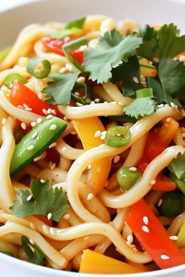 - 200g udon noodles - 6 cloves garlic, minced - 1 teaspoon red chili flakes Udon noodles are thick and chewy. They soak up flavors well. Garlic adds a strong, rich taste. Chili flakes bring heat to the dish. You can adjust the spice based on your taste. - 1 tablespoon soy sauce - 1 tablespoon oyster sauce (or mushroom sauce for a vegetarian option) - 3 tablespoons vegetable oil - 1 tablespoon sesame oil Soy sauce gives a salty kick. Oyster sauce adds depth and sweetness. Vegetable oil is great for cooking at high heat. Sesame oil adds a nutty flavor at the end. - 1 cup mixed vegetables (carrots, bell peppers, snap peas) - 2 green onions, sliced - Sesame seeds for garnish - Fresh cilantro for garnish Mixed vegetables add color and crunch. Green onions add freshness. Sesame seeds give a nice texture. Fresh cilantro brings a burst of flavor. Use these garnishes to make your dish pop! To cook the udon noodles, start with boiling water. Fill a pot with water and bring it to a rolling boil. Once boiling, add the udon noodles. Cook them for about 3 to 4 minutes, as per the package instructions. After cooking, drain the noodles and set them aside. Next, get your skillet ready. Heat 3 tablespoons of vegetable oil over medium heat. Once the oil is hot, add 6 minced garlic cloves. Sauté the garlic for about 30 seconds. Watch closely to avoid burning. Then, sprinkle in 1 teaspoon of red chili flakes. Stir it for another 15 seconds to blend the flavors. Now, it’s time to bring it all together. Add the cooked udon noodles to the skillet. Toss the noodles well to coat them in the garlic and oil mix. Pour in 1 tablespoon of soy sauce and 1 tablespoon of oyster sauce (or mushroom sauce). Stir-fry everything for 1 to 2 minutes. Next, add 1 cup of mixed vegetables like carrots, bell peppers, and snap peas. Cook for another 2 to 3 minutes until the veggies are tender yet vibrant. Finally, drizzle 1 tablespoon of sesame oil over the noodles. Toss everything one last time. Remove from heat and garnish with sliced green onions, sesame seeds, and fresh cilantro before serving. Enjoy your delicious Minute Chili Garlic Udon! To make great udon noodles, first, don't overcook them. Follow the package instructions closely. Usually, you will boil them for about 3-4 minutes. Check them a minute early to keep them chewy. For a chewy texture, rinse the cooked noodles under cold water. This stops the cooking process and helps keep them firm. Toss them with a bit of oil to avoid sticking. If you want more heat, you can add more chili flakes. Start with one teaspoon and increase as you like. Remember, a little goes a long way! You can also try other spices. Consider using fresh ginger for warmth or a dash of black pepper for depth. To boost flavor, think about using different sauces. Swap soy sauce for tamari if you want a gluten-free option. You can also add hoisin sauce for a sweet touch. Garnishing with fresh herbs makes a big difference. Cilantro adds freshness, while green onions bring crunch. Don't forget the sesame seeds for a nutty finish! {{image_2}} To make Minute Chili Garlic Udon vegetarian or vegan, swap the oyster sauce for mushroom sauce. This keeps the umami flavor but fits plant-based diets. If you want more protein, you can use tofu instead of meat. Tofu absorbs flavors well, making it a great choice. You can add chicken, beef, or tofu to your udon. For chicken, use thin slices and cook until no longer pink. If using beef, choose tender cuts and cook quickly. For tofu, press it to remove water, then cube it. Cook it until golden for a nice texture. Each protein adds its unique taste. Mix in seasonal veggies to change things up. Carrots, bell peppers, and snap peas are great, but feel free to add broccoli, zucchini, or bok choy. Each veggie brings its own flavor and texture. Adjust cooking time based on the veggies you choose. Cook until they are bright and tender for the best taste. To store leftovers, wait for the udon to cool. Place it in an airtight container. This keeps air out and helps maintain freshness. Try to eat it within two days for the best taste. For reheating, you can use a skillet or microwave. Heat a bit of oil in a skillet. Add the udon and stir until warm. If using a microwave, place it in a bowl with a splash of water. Cover it and heat in short bursts. This helps avoid sogginess and keeps the noodles tasty. Yes, you can freeze this dish! To freeze, cool the udon completely before packing it in a freezer-safe bag. When you want to enjoy it again, take it out and thaw it in the fridge overnight. Reheat it using your preferred method. This way, you can enjoy your Minute Chili Garlic Udon any time! Udon noodles usually cook in about 3-4 minutes. Boil water and add the noodles. After cooking, drain them and set them aside. This quick step gives you soft, chewy noodles that are perfect for your dish. Yes, you can make this dish gluten-free. Look for gluten-free udon noodles made from rice or other grains. These options work well and keep the dish tasty. Just check the package for cooking times, as they may vary. You can use many vegetables based on what you have. Try broccoli, zucchini, or bell peppers. Seasonal veggies like asparagus or snap peas are great, too. Just chop them small so they cook evenly and stay bright. This dish has moderate protein. Udon noodles provide some, but the garlic and vegetables add little. If you want more protein, add chicken, tofu, or shrimp. These options make the meal heartier while keeping it delicious. This article discussed how to make a tasty noodle dish with udon noodles. We covered the key ingredients like udon, garlic, and sauces. I shared step-by-step cooking instructions, plus tips for perfect texture and flavor. You can try vegetarian options or add proteins like chicken or tofu. In the end, cooking this meal is fun and rewarding. Adjust the spices and toppings to fit your taste. Enjoy experimenting with seasonings and ingredients to make it your own!