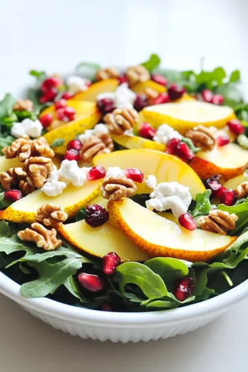 - 2 ripe pears, thinly sliced - 4 cups mixed greens (arugula, spinach, and kale) - 1/4 cup dried cranberries - 1/4 cup pomegranate seeds Fresh produce makes this salad vibrant and tasty. Ripe pears add sweetness. Mixed greens provide a crunchy base. Dried cranberries give a hint of tartness. Pomegranate seeds add a pop of color and flavor. - 1/2 cup goat cheese, crumbled - 1/3 cup walnuts, toasted and chopped Goat cheese brings creaminess to the salad. Its tangy flavor contrasts well with the sweet pears. Toasted walnuts add a nutty crunch. They also boost the salad's nutrition and flavor. - 3 tablespoons olive oil - 1 tablespoon apple cider vinegar - 1 teaspoon Dijon mustard - Salt and pepper to taste A simple dressing ties the salad together. Olive oil adds richness. Apple cider vinegar brings brightness. Dijon mustard adds a slight kick. Salt and pepper enhance all the flavors. This combination creates a balanced and fresh dressing. To start, I toast the walnuts. Place them in a dry skillet over medium heat. Stir them often for 5 to 7 minutes. You will know they are done when they smell good and turn golden. This step brings out their flavor. Next, I slice the pears. I use two ripe pears for this salad. I cut them into thin slices. This makes them easy to mix and ensures they stay pretty. Now, I mix the greens. I use 4 cups of mixed greens. My favorite mix includes arugula, spinach, and kale. I toss these together in a large bowl. This mix adds color and crunch to the salad. Now, I make the dressing. In a small bowl, I whisk together 3 tablespoons of olive oil, 1 tablespoon of apple cider vinegar, and 1 teaspoon of Dijon mustard. I add salt and pepper to taste. This mixture brings a tangy flavor to the salad. I taste the dressing after whisking. If needed, I adjust the seasoning. Just a pinch more salt or pepper can make a big difference. It's time to assemble the salad. In the large bowl with mixed greens, I add the sliced pears, toasted walnuts, 1/4 cup of dried cranberries, and 1/4 cup of pomegranate seeds. I combine all these elements gently. Next, I drizzle the dressing over the salad. I toss everything together, but I am careful. I don’t want to mash the pears; they need to stay fresh and beautiful. Finally, I sprinkle 1/2 cup of crumbled goat cheese on top. This adds a creamy texture and rich flavor. I serve the salad right away for the best taste. Enjoy your fresh, tasty delight! - Choosing ripe pears: Look for pears that feel slightly soft when you press them. They should smell sweet. Avoid pears that are too hard or have dark spots. Ripe pears add a nice sweetness to your salad. - Toasting walnuts for maximum flavor: Toast walnuts in a dry skillet over medium heat. Stir them often for about 5 to 7 minutes. They should turn golden and smell nutty. Toasting brings out their rich flavor, making your salad even more delicious. - Rustic serving ideas: Serve the salad in a large wooden bowl. This gives it a cozy, autumn feel. The natural wood complements the colors of the salad well. - Garnishing tips with pomegranate seeds: Sprinkle extra pomegranate seeds on top before serving. They add bright color and a pop of flavor. You can also add whole walnuts for a nice touch. - Pairing with proteins: This salad goes well with grilled chicken or shrimp. You can also add sliced steak for a heartier meal. The protein balances the lightness of the salad. - Ideal occasions for serving: Serve this salad at fall gatherings, holiday dinners, or casual lunches. It’s fresh and festive, making it perfect for any autumn occasion. {{image_2}} You can easily change up the nuts in your salad. Instead of walnuts, try pecans or almonds. Both add nice crunch and flavor. If you want a different cheese, feta or blue cheese works well too. Each brings its own taste. Feta adds a salty kick, while blue cheese gives a bold flavor. This salad shines with fall veggies. Roasted squash adds sweetness and warmth. You can also add other fruits like apples or figs. Apples give a crisp bite, while figs add a chewy texture. These swaps can make your salad unique every time. Homemade vinaigrettes can elevate your salad. Mix olive oil and vinegar to create a fresh base. Adding herbs like basil or thyme can boost flavor. You can also try spices like cumin or paprika for extra zing. Experimenting with dressings makes each salad special. To keep your Pear & Goat Cheese Autumn Salad fresh, store it in an airtight container. This helps prevent the greens from wilting. Aim to eat leftovers within two days for the best taste. Always check for freshness before eating. You can prep ingredients like pears, nuts, and cheese separately. This keeps everything fresh and crisp. Mix the greens and toppings together before serving. Assemble the salad just before you eat. This helps maintain the best flavors and textures. You cannot freeze the salad once it is mixed. Freezing will change the texture of the greens. However, you can freeze nuts and cheese. For nuts, place them in a sealed bag and remove air before freezing. To thaw, leave them at room temperature. For cheese, let it sit in the fridge overnight to soften. To make this salad quickly, follow these steps: 1. First, toast the walnuts in a dry skillet on medium heat. Stir them for about 5-7 minutes until they smell good and turn golden. 2. Next, in a small bowl, combine olive oil, apple cider vinegar, Dijon mustard, salt, and pepper. Whisk until mixed well. 3. In a large bowl, mix the greens, sliced pears, toasted walnuts, dried cranberries, and pomegranate seeds. 4. Drizzle the dressing over this mix and toss gently. Don’t mash the pears while tossing. 5. Finally, add crumbled goat cheese on top and serve right away for the best taste. For the best results, use a mix of greens. I recommend: - Arugula for a peppery taste. - Spinach for a mild flavor. - Kale for a hearty crunch. These greens add great texture and flavor to your salad. Yes, you can make this salad vegan with a few changes: - Replace goat cheese with vegan cheese or avocado. - Use maple syrup instead of honey in the dressing if you want added sweetness. - Ensure the Dijon mustard does not contain honey. These swaps keep the salad tasty and plant-based. This salad lasts about 1-2 days in the fridge. To keep it fresh: - Store the salad without dressing until serving. - Keep the dressing in a separate container. This way, the greens stay crisp and delicious! This salad combines fresh produce, creamy cheese, and crunchy nuts, making it delightful. I covered how to prepare the ingredients, make dressings, and assemble the dish. Important tips help enhance flavor and present beautifully. You can also explore variations and storage options to fit your needs. In giving this salad a try, you can enjoy a tasty, healthy meal any time. Now, gather your ingredients and dig into this vibrant dish!