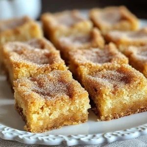 - 1 cup unsalted butter, melted - 1 cup brown sugar, packed - ½ cup granulated sugar - 2 large eggs - 2 teaspoons vanilla extract - 2 cups all-purpose flour - 1 teaspoon baking powder - ½ teaspoon baking soda - ½ teaspoon salt - 2 teaspoons cinnamon - ¼ cup granulated sugar (for topping) - 1 tablespoon ground cinnamon (for topping) When you gather the ingredients for cinnamon sugar blondies, each one plays a key role. The melted butter adds richness and moisture. Brown sugar gives that deep, caramel flavor. Granulated sugar balances sweetness and helps the blondies rise. The eggs bind the mix and add structure. Vanilla extract gives a warm aroma that pairs well with cinnamon. All-purpose flour creates the base, while baking powder and baking soda help them rise just right. Salt is essential. It enhances the flavors and balances sweetness. Finally, cinnamon is the star. It adds warmth and a cozy touch. The topping of cinnamon sugar adds a sweet crunch that you will love. Each ingredient matters. Together, they create a treat that is easy and delicious. Enjoy the simple joy of baking these blondies at home! {{ingredient_image_1}} 1. First, preheat your oven to 350°F (175°C). This step is key for even baking. 2. Next, grease a 9x13-inch baking pan. You can also line it with parchment paper. 3. In a large bowl, combine 1 cup of melted butter, 1 cup of brown sugar, and ½ cup of granulated sugar. Stir until it's smooth and well-mixed. 4. Now, add 2 large eggs, one at a time. Mix well after each egg. Then, stir in 2 teaspoons of vanilla extract. 1. In another bowl, whisk together 2 cups of all-purpose flour, 1 teaspoon of baking powder, ½ teaspoon of baking soda, ½ teaspoon of salt, and 2 teaspoons of cinnamon. This blend gives great flavor. 1. Gradually add the dry ingredients to the wet mixture. Stir gently until just combined. Be careful not to over-mix; it can make the blondies dense. 2. Pour the batter into the prepared pan. Use a spatula to spread it evenly. 3. In a small bowl, mix ¼ cup of granulated sugar with 1 tablespoon of ground cinnamon. Sprinkle this topping evenly over the batter. 1. Bake in the preheated oven for 20-25 minutes. To check if they are done, insert a toothpick into the center. It should come out clean. 2. Let the blondies cool in the pan for about 10 minutes. Then, move them to a wire rack to cool completely. To achieve the right texture, you want your blondies soft and chewy. Start by melting the butter. This gives them a rich flavor. Mix the butter with both sugars until smooth. This step is key for good blending. When you add eggs, do it one at a time. Mix well after each addition. This helps create a nice, fluffy batter. Be gentle when mixing in the dry ingredients. Stir until just combined. Over-mixing can make them tough. To slice and present your blondies, let them cool a bit first. Cut them into squares. Use a sharp knife for clean edges. Place them on a pretty plate for a nice touch. For extra flair, sprinkle some powdered sugar or cinnamon on top. You can also add toppings like nuts or chocolate chips. They bring extra texture and flavor. Serve warm with ice cream for a yummy treat. To keep blondies fresh, store them in an airtight container. This helps keep them soft. You can also place parchment paper between layers to avoid sticking. Blondies stay good for about a week at room temperature. For longer storage, you can freeze them. Wrap each blondie tightly in plastic wrap. Then place them in a freezer bag. They can last up to three months this way. Just thaw them at room temperature when you’re ready to enjoy! Pro Tips Butter Temperature: Make sure the melted butter has cooled slightly before mixing it with the sugars to prevent the eggs from scrambling. Mixing Technique: When combining the wet and dry ingredients, mix gently to maintain the blondies' soft and chewy texture. Baking Time: Check your blondies a few minutes before the suggested baking time, as ovens can vary, and you want them just set in the middle. Storage Tips: Store the blondies in an airtight container at room temperature to keep them fresh for up to a week. {{image_2}} You can make your cinnamon sugar blondies unique by adding chocolate chips or nuts. Chocolate chips bring a rich taste. I love using semi-sweet or dark chocolate for a nice contrast. Chopped nuts like pecans or walnuts add crunch. Simply fold them into the batter before pouring it into the pan. You can also switch up the spices. Instead of just cinnamon, try nutmeg or allspice for a warm flavor. Cardamom adds a floral note that pairs well with sweet treats. Mix and match to find what you love best. If you need a gluten-free option, use a gluten-free flour blend. Many brands work well in baking. Just make sure to follow the package instructions for best results. For those watching sugar intake, consider using sugar substitutes like stevia or monk fruit. These sweeteners can keep the blondies tasty without the extra calories. You may need to adjust the amount, so check the conversion ratio. For fall-inspired blondies, add pumpkin puree along with the spices. This gives a moist texture and a lovely autumn flavor. You could even stir in some chopped apples for added sweetness. During the holidays, think about using ginger or cloves. These spices can create a festive vibe. You could also top the blondies with a drizzle of icing made from powdered sugar and milk for a special treat. How do I know when blondies are done baking? Blondies are done when a toothpick comes out clean. Check them around 20 minutes. If it has wet batter, bake a bit longer. The edges will look set, but the center might still be soft. That’s perfect! Can I freeze blondies for later? Yes, you can freeze blondies. Once they cool, cut them into squares. Wrap each piece in plastic wrap and place them in a freezer bag. They can last up to three months. Just thaw them at room temperature when you’re ready to enjoy! What are the differences between blondies and brownies? Blondies are lighter and sweeter than brownies. They use brown sugar, which gives them a rich flavor. Brownies usually have cocoa powder or melted chocolate. This makes them darker and more fudgy. Both are delicious, but they offer different taste experiences. Can I use margarine instead of butter? You can use margarine, but it can change the taste. Butter adds a rich flavor that margarine may not match. If you’re out of butter, margarine works in a pinch. Just ensure it’s unsalted to keep the flavor balanced. What if I don’t have brown sugar? If you don’t have brown sugar, you can make your own. Mix one cup of granulated sugar with one tablespoon of molasses. This will mimic brown sugar’s taste and moisture. You can also use regular sugar, but the blondies will be less rich. How many servings does this recipe make? This recipe makes about 12 servings. You can cut the blondies into squares, making them easy to share. Each piece is a perfect treat for gatherings or a sweet snack at home. What is the estimated calorie count per serving? Each blondie has around 200 calories. This can vary based on the exact sizes you cut. They are a sweet indulgence, so enjoy them in moderation! - Prep Time: 15 minutes - Cook Time: 20-25 minutes - Total Time: 40 minutes - Servings: 12 Each blondie has about 200 calories. You get some carbs, fat, and protein. These blondies also have fiber from the flour. Cinnamon adds antioxidants, too! This treat is sweet and satisfying. I suggest taking mouthwatering photos of the blondies fresh from the oven. Show them cut into squares, arranged on a colorful plate. A video could show the mixing process or the final product being enjoyed. These visuals will make the recipe more appealing to readers! This blog post covered how to make tasty cinnamon sugar blondies. I shared the key ingredients, preparation steps, and tips to achieve the best texture. You learned about variations, serving suggestions, and how to store the blondies. Keep these points in mind for your baking journey. The process is simple, fun, and flexible. Enjoy making these delicious treats! Happy baking!