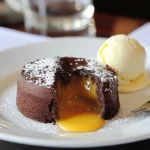 To make a flourless chocolate lava cake, you need: - 1 cup semi-sweet chocolate chips - 6 tablespoons unsalted butter - 3 large eggs - ½ cup granulated sugar - 1 teaspoon vanilla extract - ¼ teaspoon salt - ¼ cup unsweetened cocoa powder These simple ingredients create a rich and gooey dessert that everyone loves. You can enhance your cake with these extras: - Powdered sugar for dusting - Vanilla ice cream for serving These additions make your lava cake even more delightful. This dessert is naturally gluten-free since it uses no flour. If you want to make it dairy-free, you can swap the butter and chocolate for dairy-free options. Always check labels to ensure they meet your needs. {{ingredient_image_1}} Start by preheating your oven to 425°F (220°C). Grease four ramekins with unsalted butter. Make sure to cover the entire inside. Then, dust each ramekin with cocoa powder. This step helps the cakes pop out easily after baking. In a microwave-safe bowl, mix the semi-sweet chocolate chips with the unsalted butter. Heat them in the microwave for 30 seconds. Stir the mixture well after each interval. Keep doing this until it is smooth and shiny. This blend is the heart of your lava cake. In another bowl, crack three large eggs. Add the granulated sugar, vanilla extract, and salt. Whisk these together until the mix is pale and frothy. Next, pour the melted chocolate mixture into this egg mix. Fold the two together gently. Be careful not to overmix; we want a rich, smooth batter. Sift the unsweetened cocoa powder over your batter. Gently fold it in until combined. Now, divide the batter evenly among the prepared ramekins, filling each about ¾ full. Place the ramekins on a baking sheet for easy handling. Bake in your preheated oven for 12-14 minutes. The edges should be firm, but the center will still jiggle slightly. After baking, let the cakes cool for 1-2 minutes. Carefully flip each ramekin onto a serving plate. The cakes should slide out easily. If you want, dust them with powdered sugar for a nice touch. Serve warm, and don't forget a scoop of vanilla ice cream for extra delight! To get that gooey center, watch your baking time closely. Bake the cakes for 12 to 14 minutes. The edges should feel firm, but the center must jiggle. If you bake too long, the center will cook through. Use a timer to help you avoid overbaking. Every oven is different, so check a minute early. Trust me, the perfect lava cake is all about timing. If you have any leftover lava cakes, store them in the fridge. Place them in an airtight container to keep them fresh. They will last for about three days. When you’re ready to eat them, reheat in the microwave. Heat for about 20 seconds. This warms them without losing the gooey center. Enjoy them warm for the best taste. The type of chocolate you use makes a big difference. I recommend semi-sweet chocolate chips for a rich flavor. Dark chocolate works too, if you want a more intense taste. Just remember, the better the chocolate, the better the cake. Look for high-quality brands with simple ingredients. Always choose chocolate you love to eat on its own. Pro Tips Perfect Chocolate Melting: To avoid scorching the chocolate, melt it in short 30-second intervals, stirring in between to ensure even melting without burning. Check for Doneness: The ideal lava cake should have firm edges and a soft, gooey center. If unsure, do a toothpick test; it should come out with moist crumbs, not wet batter. Cooling Time: Allow the cakes to cool for just 1-2 minutes before inverting. This helps set the edges while keeping the center molten. Serving Suggestions: For an extra touch of elegance, serve with a dollop of whipped cream or a fresh raspberry alongside the vanilla ice cream. {{image_2}} You can spice up your flourless chocolate lava cake with fun flavors. Want a minty twist? Just add a few drops of mint extract to the batter. This will give it a cool and fresh taste. If you love coffee, add one tablespoon of instant coffee granules. It brings out the chocolate flavor nicely. For a fruity touch, mix in some orange zest. Each flavor adds a new layer of fun to this dessert. If you want a healthier cake, switch the granulated sugar. You can use coconut sugar or maple syrup. Coconut sugar has a lower glycemic index, so it’s a bit better for your health. If you use maple syrup, reduce the amount of butter slightly. This keeps the cake moist while making it a bit lighter. These swaps keep the richness you love but make it a tad healthier. Want to make this cake gluten-free? You're already set! The recipe contains no flour. For a dairy-free option, use vegan chocolate chips and coconut oil instead of butter. The taste remains rich and delicious. If you have egg allergies, try using flax eggs. Mix one tablespoon of ground flaxseed with three tablespoons of water for each egg. Let it sit until it thickens. These swaps help you enjoy this tasty dessert no matter your dietary needs. To store leftover lava cakes, let them cool first. Place them in airtight containers. Keep them in the fridge for up to three days. If you want to enjoy them later, wait to dust with powdered sugar until you're ready to serve. This keeps them looking fresh. When you're ready to eat, reheat the lava cakes. Preheat your oven to 350°F (175°C). Place the cakes on a baking sheet. Heat for about 8-10 minutes. This warms them without overcooking. You can also use the microwave. Heat on low for about 20-30 seconds. Check to see if they are warm enough. If you want to save lava cakes for later, freezing is a great option. Wrap each cooled cake tightly in plastic wrap. Then, place them in a freezer-safe bag. They can last up to three months. When you want to eat one, take it out and thaw it in the fridge overnight. Then, reheat as needed. Enjoy that molten center again! Yes, you can use dark chocolate or milk chocolate. Dark chocolate gives a rich taste. Milk chocolate offers a sweeter flavor. Just keep the same amount of chocolate chips. Adjust the sugar if you use a sweeter chocolate. Watch the edges closely while baking. They should be firm and set. The center should jiggle slightly when you shake the ramekin. If it looks too firm, it may not have a molten center. You can serve it with a scoop of vanilla ice cream. The cold ice cream pairs well with the warm cake. Fresh berries also add a nice touch. A sprinkle of powdered sugar makes it look fancy too. Yes, you can make the batter ahead of time. Just cover it and keep it in the fridge. When ready to bake, pour it into the ramekins and bake as usual. It’s a great way to save time before a dinner party! In this article, we explored making delicious chocolate lava cakes. You learned about the key ingredients and optional items to serve. I shared step-by-step instructions for perfecting your cakes, along with useful tips to achieve that molten center. We also discussed fun variations to customize your cakes and smart storage practices. As you try this recipe, have fun experimenting! Enjoy the rich flavors and warm centers. Happy baking!