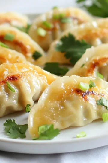 - 1 pound raw shrimp, peeled and deveined - 1 tablespoon ginger, finely minced - 2 green onions, finely chopped - 1 clove garlic, minced - 10-12 round dumpling wrappers The heart of these dumplings is the shrimp. Using fresh, raw shrimp gives the best flavor. I like to peel and devein them myself. This way, I know they are fresh. I also add ginger and green onions for a bright taste. Ginger adds a warm spice, while green onions bring a nice crunch. The garlic adds depth, making each bite full of flavor. For the dumpling wrappers, I prefer round ones. They hold the filling well and are easy to fold. - 1 tablespoon soy sauce - 1 teaspoon sesame oil - Salt and pepper to taste Seasonings make this dish pop! Soy sauce provides a savory base. Sesame oil adds a nutty flavor. Together, they make the shrimp taste amazing. I also sprinkle in salt and pepper to enhance the flavors. Adjust these to your liking; cooking should be fun! - Fresh cilantro, for garnish - Dipping sauce options: soy sauce, chili oil Garnishes are key to a great dish. I love adding fresh cilantro for color and freshness. It brightens up the dumplings. For dipping, soy sauce is a classic choice. If you want some heat, chili oil adds a nice kick. Mixing these options lets you customize your flavor experience! {{ingredient_image_1}} To make the filling, use a food processor. Add the raw shrimp, ginger, green onions, garlic, soy sauce, sesame oil, salt, and pepper. Pulse the mix until it is almost smooth. You want small bits of shrimp to remain for texture. This gives your dumplings a nice bite. Now, let’s fill the dumplings. Take a dumpling wrapper and scoop about a teaspoon of the shrimp filling into the center. Moisten the edges with a little water. Fold the wrapper in half to create a half-moon shape. Pinch the edges tightly to seal the dumpling. Make sure there are no openings. Repeat this process until you fill all the wrappers. Next, we will cook the dumplings. Set up a steamer pot on your stove and fill it with water. Bring the water to a gentle simmer. Place the dumplings in the steamer basket. Make sure they have space and are not crowded. Cover the steamer and cook for about 5 to 6 minutes. The shrimp filling should be fully cooked when done. You can tell they are ready when they are firm and cooked through. Remove the dumplings and let them cool slightly before serving. To make the best dumplings, avoid overfilling. Filling them too much can cause the wrappers to tear. Use about one teaspoon of filling per wrapper. This amount gives enough taste without risking a mess. When sealing dumplings, moisture is key. Moisten the edges of the wrapper with a little water. This helps the edges stick together better. After folding the wrapper, pinch the edges tightly. This keeps the filling inside while cooking. To amp up the taste, experiment with herbs and spices. Fresh cilantro adds brightness. Try adding a sprinkle of chili flakes for heat. You can also mix in some lime zest for a citrus kick. Choosing the right dipping sauce can elevate your meal. Soy sauce is classic, but you could try chili oil for a spicy twist. You can mix soy sauce with vinegar for a tangy option. A food processor makes mixing easy. It gives a smooth texture to the filling. A good steamer is also important. Use a bamboo or metal steamer for best results. When using the steamer, fill it with water just below the basket. Make sure the dumplings don’t touch the water. Cover the steamer tightly to keep the steam in. This way, your dumplings cook evenly. Pro Tips Prep Your Ingredients: Ensure all ingredients are prepped and within reach before starting. This will make the assembly process smoother and quicker. Seal the Dumplings Well: Make sure to moisten the edges of the dumpling wrappers adequately to ensure a tight seal. This prevents the filling from leaking during cooking. Don’t Overcrowd the Steamer: Steam the dumplings in batches if necessary. Overcrowding can lead to uneven cooking and sticking. Experiment with Dipping Sauces: Try different dipping sauces like soy sauce mixed with rice vinegar or spicy chili oil to enhance the flavor of your dumplings. {{image_2}} If you can't find shrimp, you can use chicken or tofu. For chicken, use cooked, shredded chicken. You can season it the same way as shrimp. For tofu, choose firm tofu. Press it to remove excess water, then mash it. Spice it up with ginger and garlic for flavor. For vegan options, use mushrooms, carrots, and bok choy. These veggies add a nice crunch. Blend them in a food processor like you do with shrimp. This gives your dumplings a fresh taste. You can cook dumplings in different ways. Pan-frying gives a crispy bottom. Heat oil in a pan, add dumplings, and cook until golden. Then, add water and cover to steam them. Boiling is another quick method. Just bring water to a boil, add dumplings, and cook for about 3-4 minutes. Baking is easier too. Preheat your oven and bake for about 15-20 minutes. This way, you get a nice golden color. Want to spice things up? Add red pepper flakes or sriracha to the filling. This gives your dumplings a nice kick. You can also mix in vegetables like finely chopped bell peppers or spinach. These add color and nutrition. Experiment with herbs too! Fresh basil or cilantro can enhance the taste. You can even try adding a splash of lime juice for a zesty twist. Each change makes your dumplings unique. Store your dumplings in the fridge for best results. Place them in an airtight container. This keeps them fresh and prevents them from drying out. They stay good for about 2-3 days. If you want to enjoy them later, think about freezing them. To freeze dumplings, first place them on a baking sheet. Make sure they do not touch each other. Freeze them for about 1-2 hours, until firm. After that, you can move them to a freezer bag. This helps save space. They can last up to 3 months in the freezer. When you're ready to eat, thaw them in the fridge overnight. Reheat your dumplings in a steamer for best texture and flavor. Just steam them for about 3-5 minutes until hot. You can also pan-fry them for a crispy finish. If you choose the microwave, cover them with a damp paper towel to keep moisture. This way, they won’t get tough. Enjoy your dumplings fresh! Shrimp dumplings last about 2 to 3 days in the fridge. Store them in an airtight container. This keeps them fresh and tasty. If you notice any odd smells or colors, it’s best to discard them. Yes, you can make shrimp dumplings ahead of time. Prepare the dumplings and place them on a tray. Cover them with plastic wrap and store them in the fridge for up to 24 hours. This way, you can steam them quickly when you’re ready to eat. Soy sauce and chili oil make a great dip for shrimp dumplings. You can also try sweet soy sauce or vinegar for a different taste. Feel free to mix and match! Shrimp dumplings are a delightful treat you can make at home. We covered the main ingredients, how to prepare the filling, and cooking tips. Remember to experiment with flavors and cooking methods for variety. Proper storage keeps your dumplings fresh for later. With these steps, you'll make tasty dumplings that impress. Enjoy the process, and happy cooking!