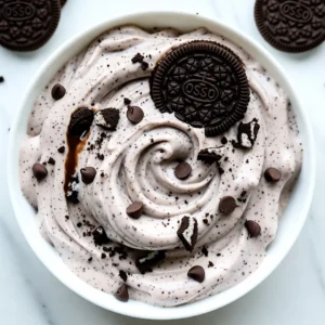 To make this tasty no-churn cookies and cream ice cream, you need: - 2 cups heavy whipping cream - 1 cup sweetened condensed milk - 2 teaspoons vanilla extract - 1 cup chocolate sandwich cookies (like Oreos), crushed - ½ cup mini chocolate chips - Pinch of sea salt These ingredients create a creamy base and a rich flavor. The heavy cream gives it a nice texture. The sweetened condensed milk adds sweetness and creaminess. The vanilla extract boosts the flavor. Finally, the cookies and chocolate chips add crunch and fun. You can get creative with your ice cream! Here are some mix-ins and toppings to try: - Chopped nuts for extra crunch - Swirls of chocolate or caramel sauce - Mini marshmallows for a fluffy touch - Different flavored cookies, like peanut butter or mint Feel free to mix and match! These options let you customize the ice cream to your taste. To make this ice cream, you'll need a few simple tools: - Large mixing bowl - Electric mixer (or a whisk if you want a workout!) - Rubber spatula for folding - Freezer-safe container with a lid Having the right tools makes the process easier and more fun. Make sure your container is airtight to keep the ice cream fresh. {{ingredient_image_1}} To start, grab a large mixing bowl. Add 2 cups of heavy whipping cream. Use an electric mixer on medium-high speed. Whip the cream until it forms stiff peaks. This takes about 4-5 minutes. The peaks should stand tall when you lift the mixer. This step gives your ice cream its light and airy texture. Next, take another bowl. Combine 1 cup of sweetened condensed milk, 2 teaspoons of vanilla extract, and a pinch of sea salt. Stir the mixture until it blends well. The sweetened condensed milk adds creaminess to your ice cream. The vanilla extract boosts the flavor. The sea salt enhances all these yummy tastes. Now, gently fold the whipped cream into the condensed milk mixture. Use a rubber spatula for this. Be careful not to deflate the whipped cream. You want to keep it light. Once combined, fold in 1 cup of crushed chocolate sandwich cookies and ½ cup of mini chocolate chips. Spread the mixture into a freezer-safe container. Smooth the top with your spatula. Cover it with a lid or plastic wrap. Freeze for at least 4-6 hours, or until it is completely solid. Before serving, let it sit out for 5-10 minutes. This makes scooping easier. For the best texture, whip your heavy cream until it forms stiff peaks. This means the cream should stand tall when you lift the mixer. Be patient, as this takes about 4-5 minutes. The air you whip into the cream makes your ice cream light and fluffy. When mixing the whipped cream with the other ingredients, fold gently. This keeps the air in, giving you that perfect creamy bite. One common mistake is over-mixing the whipped cream. If you mix too much, it can turn grainy. Always fold instead of stirring. Another mistake is not letting the ice cream sit out before scooping. If you dive right in, it can be hard to scoop. Give it 5-10 minutes at room temp. Lastly, don’t skip the pinch of sea salt. It makes the flavors pop. Serve your ice cream in waffle cones or bowls for a fun touch. You can top it with extra crushed cookies for added crunch. A drizzle of chocolate syrup makes it even better. For a special treat, add whipped cream on top. This ice cream is great for parties or a cozy night in. Enjoy every creamy bite! Pro Tips Use Cold Equipment: Ensure your mixing bowls and beaters are chilled before whipping the cream for a better volume and stability. Experiment with Flavors: Add a splash of almond extract or a hint of mint for a unique twist on the classic cookies and cream flavor. Texture Matters: For a smoother texture, consider blending the crushed cookies into a fine powder before mixing it in. Serving Suggestions: Pair this dessert with fresh berries or a scoop of vanilla ice cream for a delightful contrast in flavors. {{image_2}} You can make this ice cream even more fun by adding flavors. Mint is a great choice. Just mix in a few drops of mint extract when you blend the sweetened condensed milk. You can also stir in some creamy peanut butter for a rich taste. Use about half a cup to keep it balanced. These flavors give a twist to the classic cookies and cream. While chocolate sandwich cookies are a must, you can switch them out. Try golden Oreos for a light twist. You can even use chocolate chip cookies for a chewy texture. Each cookie type changes the flavor. Experiment with your favorites to find the perfect mix. If you want a dairy-free treat, it’s easy to swap ingredients. Use coconut cream in place of heavy cream. Use a dairy-free condensed milk for sweetness. You can find many brands at the store now. Just make sure your cookies are vegan as well. This way, everyone can enjoy a scoop of this tasty delight! Store leftover ice cream in a freezer-safe container. Make sure to cover it tightly with a lid or plastic wrap. This keeps air out and prevents ice crystals. Sealing it well helps maintain its creamy texture. If you have space, use a shallow container for quicker freezing. To keep your no-churn cookies and cream ice cream fresh, freeze it right after making it. It’s best to freeze it at a consistent temperature. Avoid opening the freezer too often. If ice crystals form, just stir the ice cream before serving. This will help restore its smoothness. No-churn ice cream lasts about two weeks in the freezer. After that, it may lose flavor and texture. If you notice any freezer burn, it’s best to toss it. To enjoy the best taste, eat it within the first week. You’ll love its creamy goodness while it's fresh! Yes, you can use lactose-free heavy cream and sweetened condensed milk. Many brands offer these options. They work just as well in the recipe. This way, everyone can enjoy the ice cream. You can whip the heavy cream by hand. Use a large whisk and a big bowl. It will take longer, around 10-15 minutes. Just keep whisking until you see stiff peaks. Your arm might get tired, but the ice cream will still be great! It takes about 4-6 hours to freeze. To be sure it's solid, check after 4 hours. If it’s not firm, let it freeze longer. Be patient; the waiting will be worth it! No-churn ice cream is easy and fun to make. We covered essential ingredients, from whipped cream to mix-ins. I shared step-by-step instructions for a creamy treat, plus tips for the best texture. You can explore fun variations, like mint or peanut butter, and learn how to store leftovers well. Remember to avoid common mistakes for perfect results. I hope you feel inspired to create this delicious dessert at home! Enjoy your tasty adventure with no-churn ice cream.